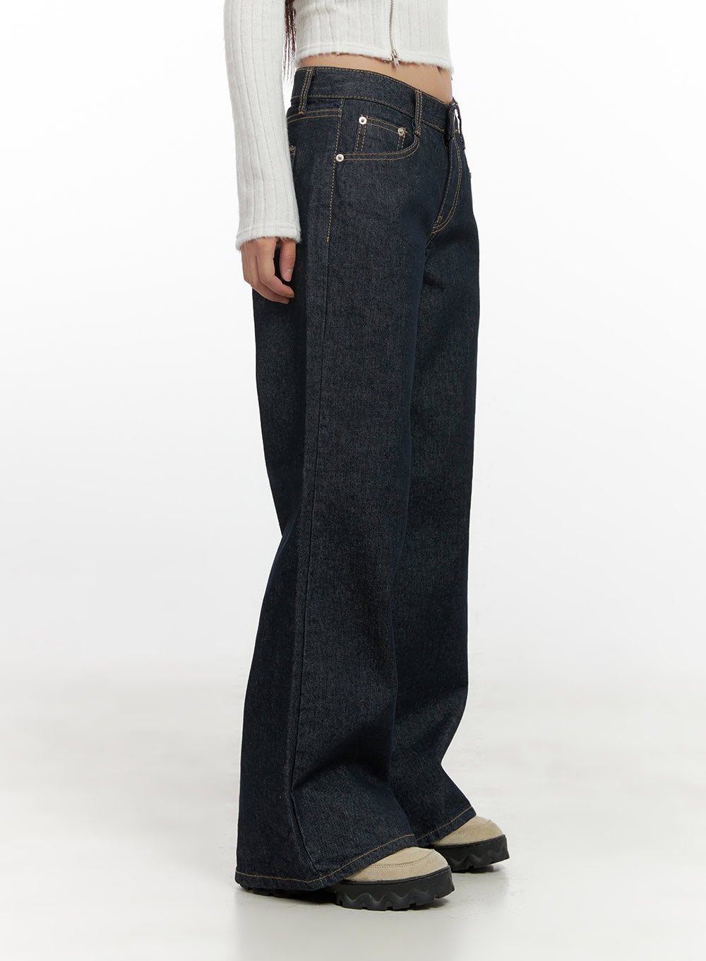 Lisa Cotton Comfort Wide Leg Jeans CN419 in dark blue, side close-up on model, low-rise wide-leg cotton denim highlighting side seam silhouette and gold contrast stitching, with white ribbed crop top.