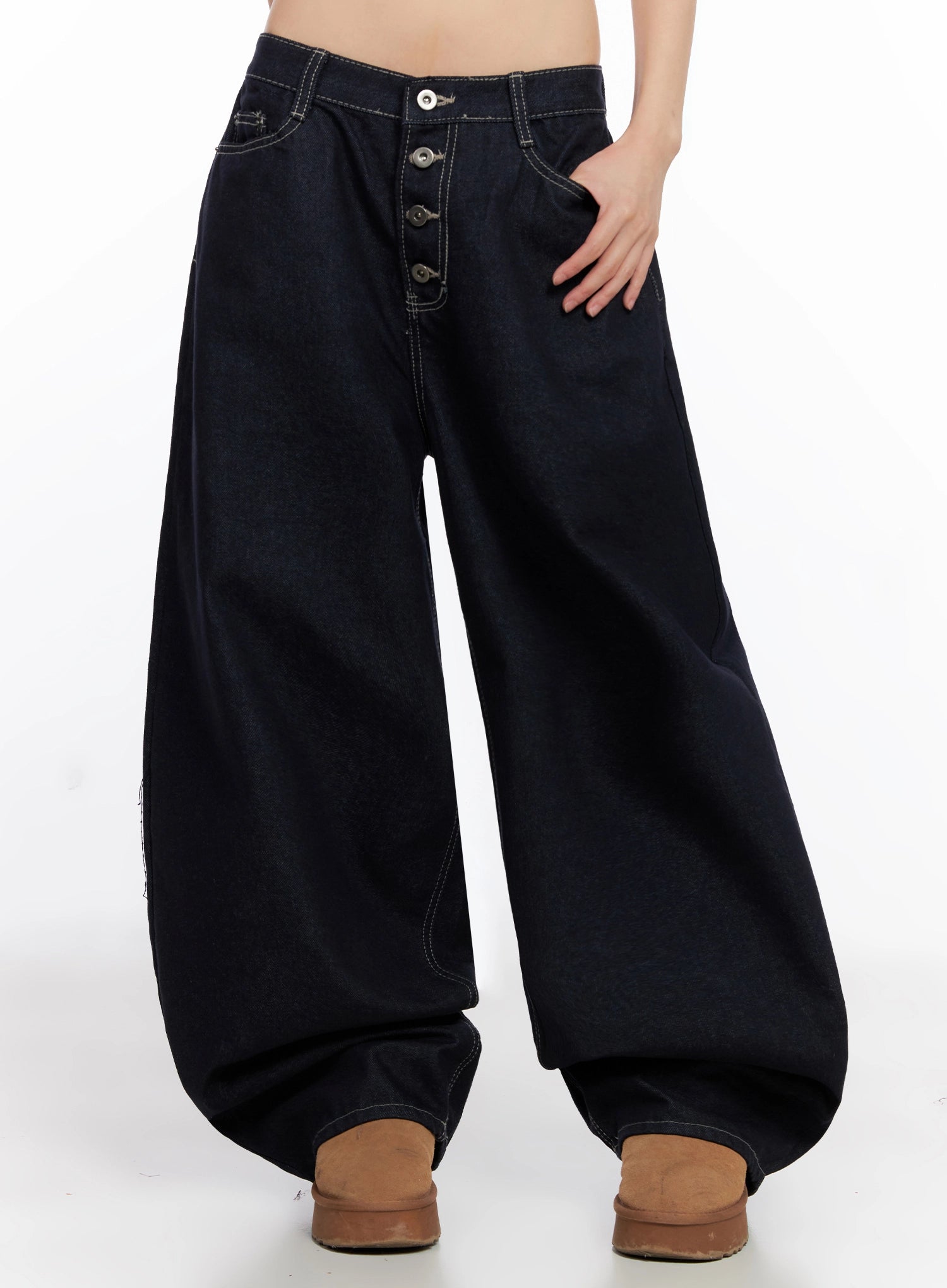 Jazlyn Non-Fade Button Wide Leg Jeans IN503 in dark blue, three-quarter front view on model, hand in pocket, showing voluminous wide leg silhouette, button closure, and contrast topstitching.