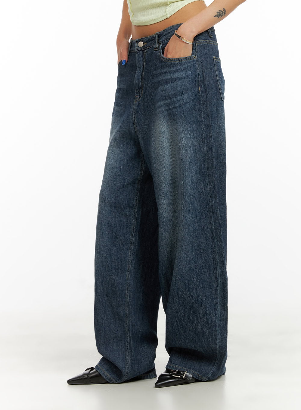 Low Rise Wide Fit Baggy Jeans CY431 in dark blue, side close-up waist-to-hem on model, low rise washed cotton denim, oversized wide leg with faded whiskering detail, hand in front pocket.