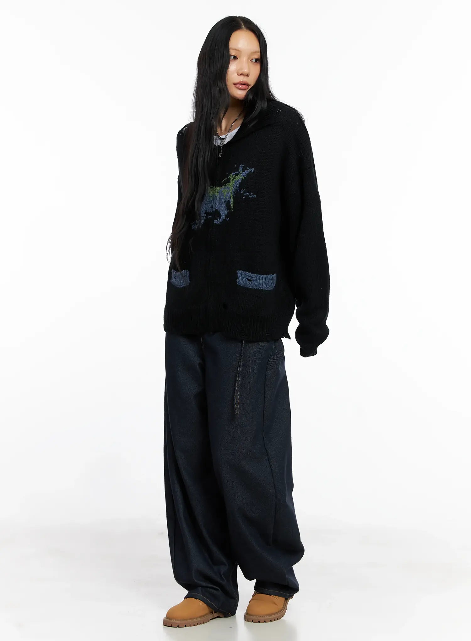 Alanna Sun Belt Baggy Jeans CO528 in dark indigo, three-quarter front view on model, voluminous baggy silhouette, low-rise waist with sun belt ring, styled with oversized black knit cardigan.