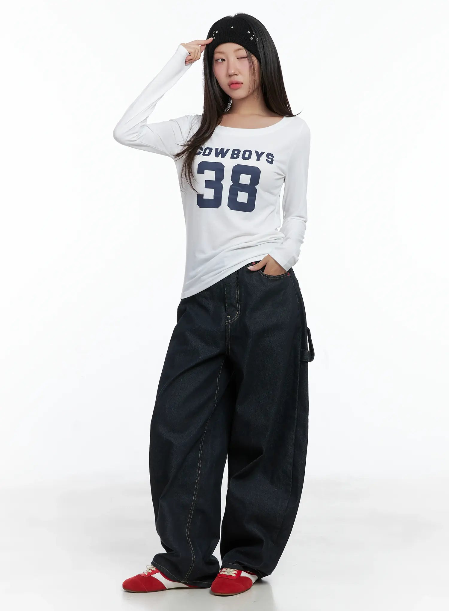 Heart Pocket Balloon Jeans CS503 in dark indigo, full front view on model, wide-fit balloon leg, yellow contrast stitching, styled with white graphic long-sleeve top and red sneakers.