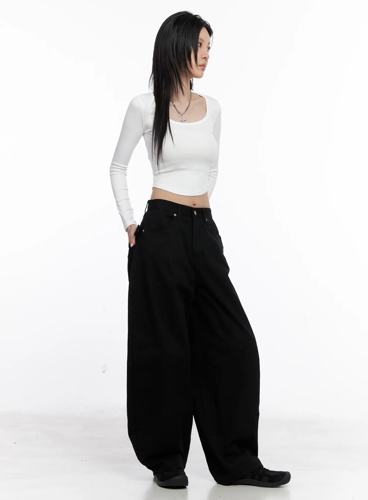Nana Studded Belt Balloon Jeans CS512 in black, three-quarter front-side view on model, hands in pockets, paired with white crop top, balloon leg drape and low rise waist shown.