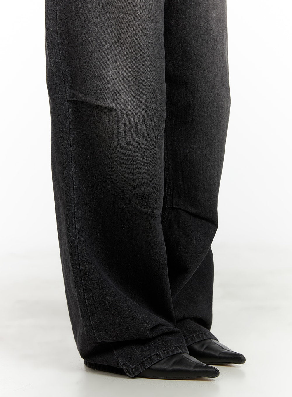 Pintuck Washed Denim Wide Leg Jeans CA419 in black, lower-leg close-up on model, showing pintuck panel seam, wide hem pooling over black pointed-toe boots.