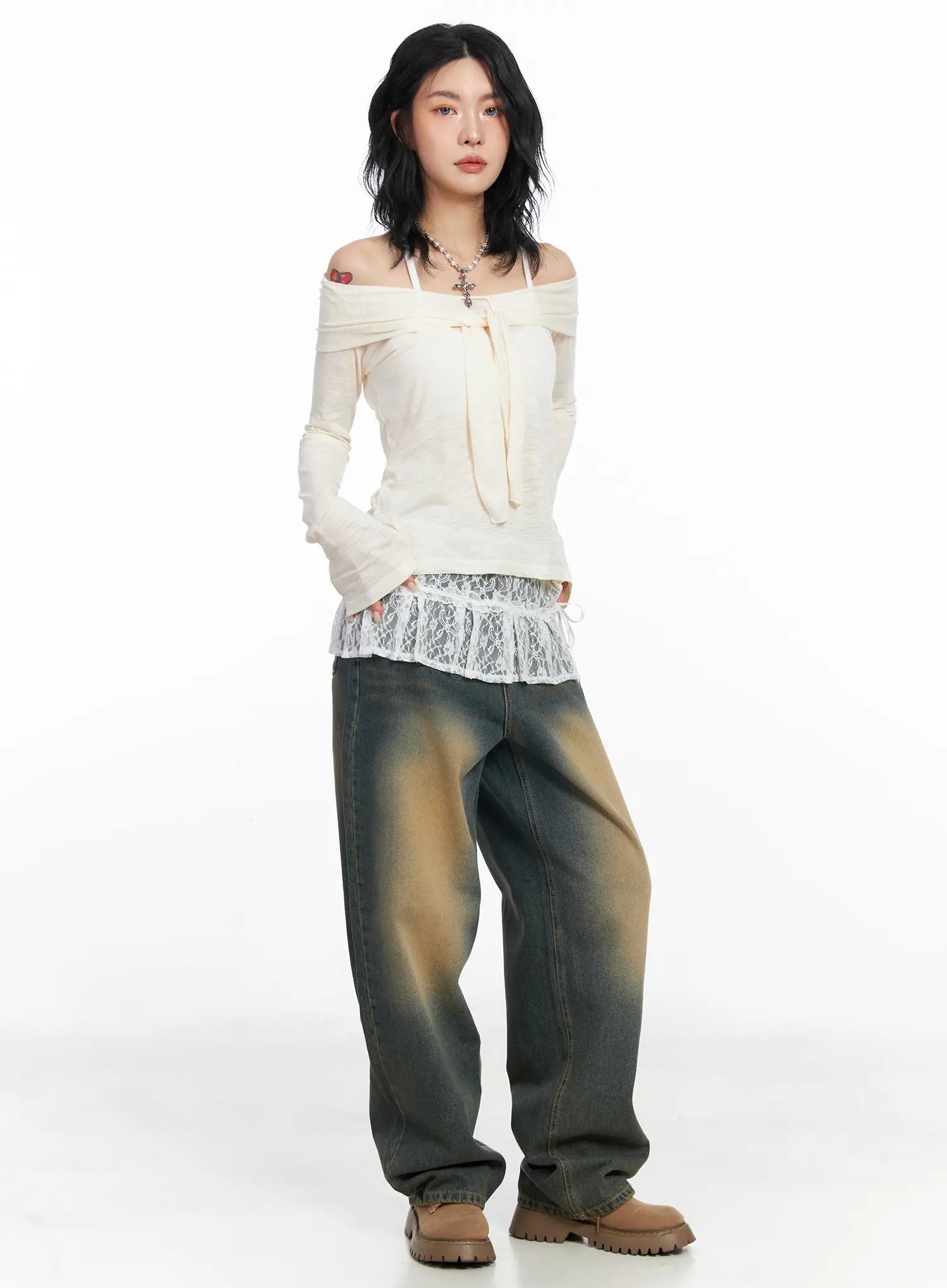 Karsyn Vintage Baggy Jeans CJ522 in dark blue, three-quarter front view on model, wide-fit washed denim styled with cream off-shoulder lace-trim top and chunky boots.