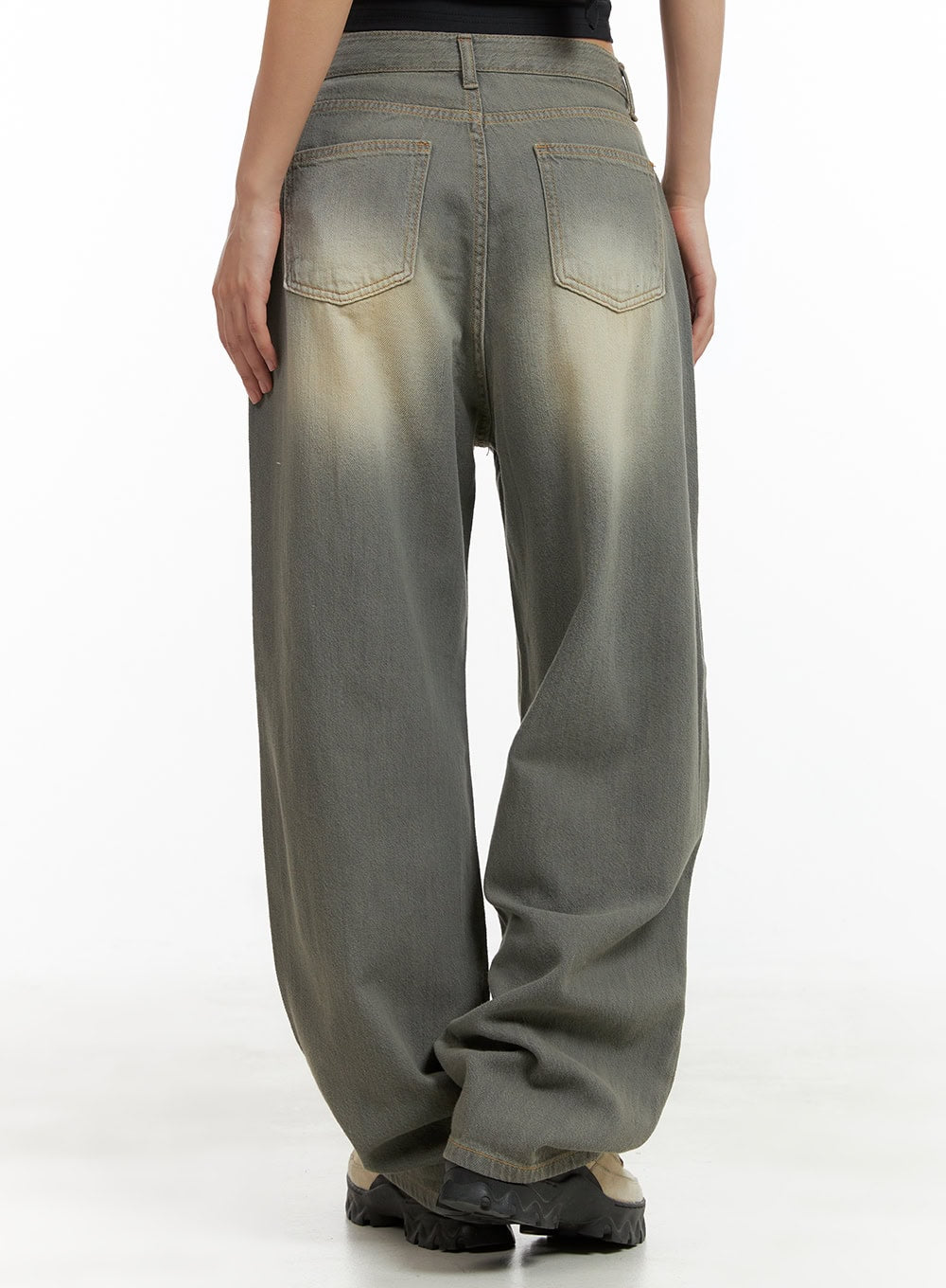 Washed Baggy Denim Jeans CU404 in Brown, back close-up on model, two back patch pockets with sun-faded golden wash detail, wide baggy leg pooling at hem over sneakers.