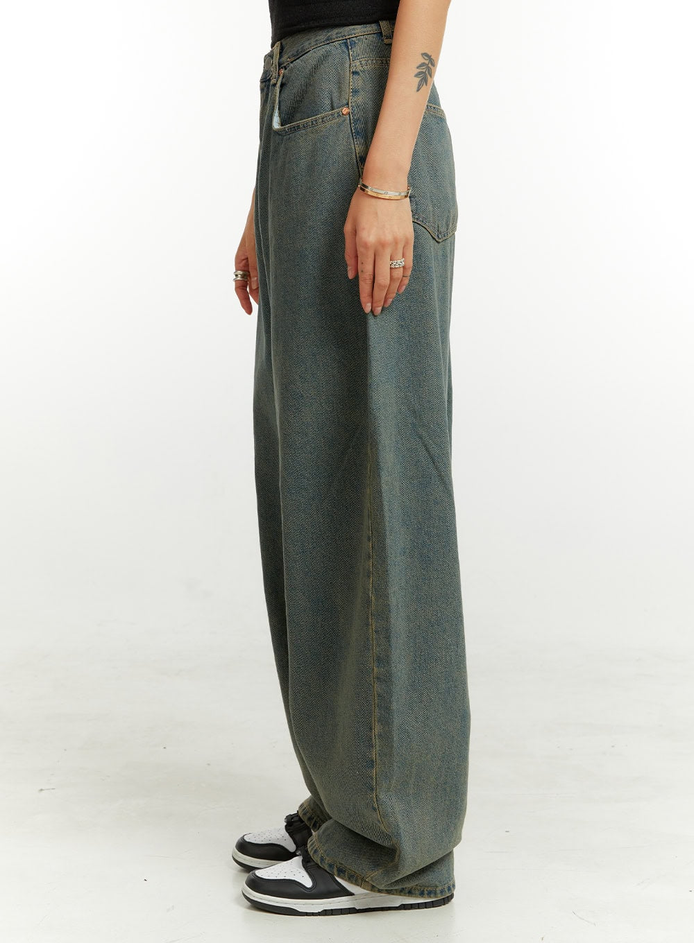 Denim Washed Baggy Jeans CU424 in blue, side profile view on model, highlighting extreme wide-leg balloon shape and washed denim fade, with front pocket detail visible.