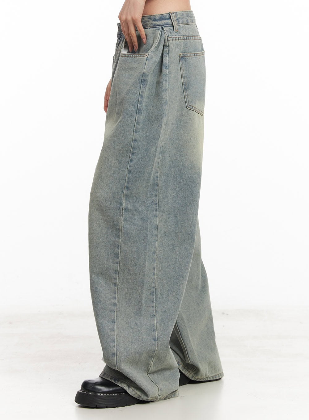 Hillary Washed Wide-Leg Jeans CM504 in light blue, side close-up on model, highlighting pintuck pleat, washed gradient denim, and sweeping wide leg silhouette with black loafers.