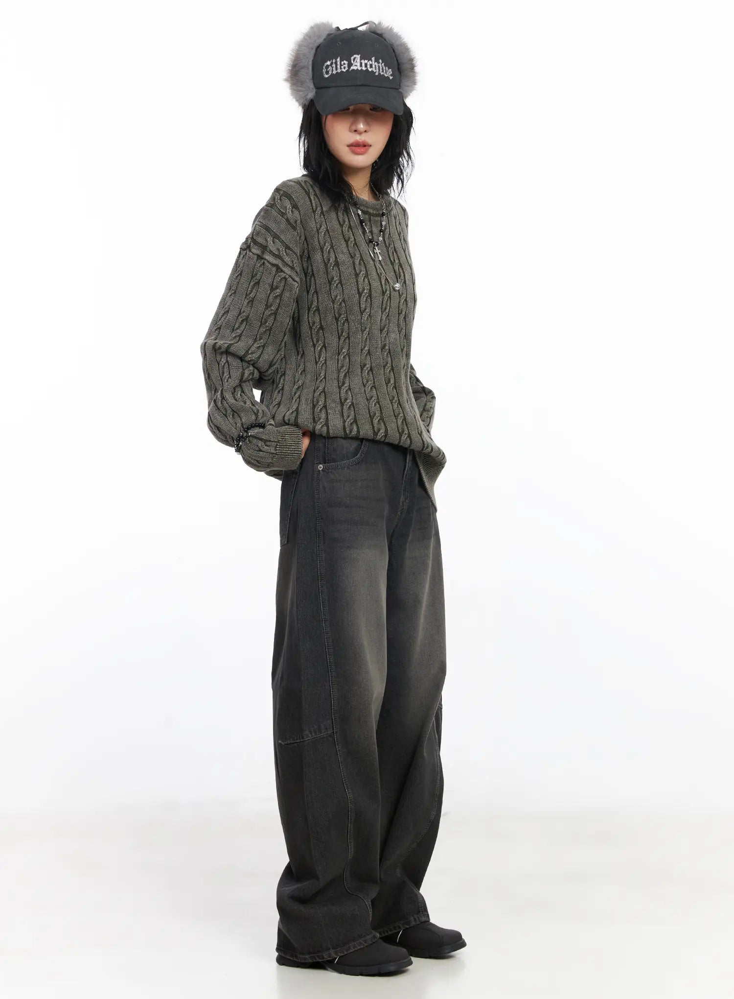 Nayeli Baggy Jeans CJ522 in dark gray, full-body side shot on model, long wide-leg washed denim paired with oversized gray cable-knit sweater and fur-trim cap.