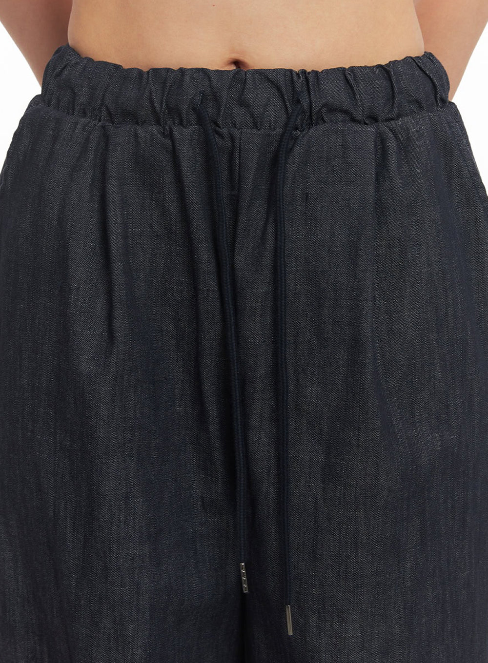 Cotton Denim Wide-Leg Pants IY509 in dark navy, macro close-up of waistband detail showing ruched elastic band and adjustable drawstring with metal tip on cotton denim fabric.