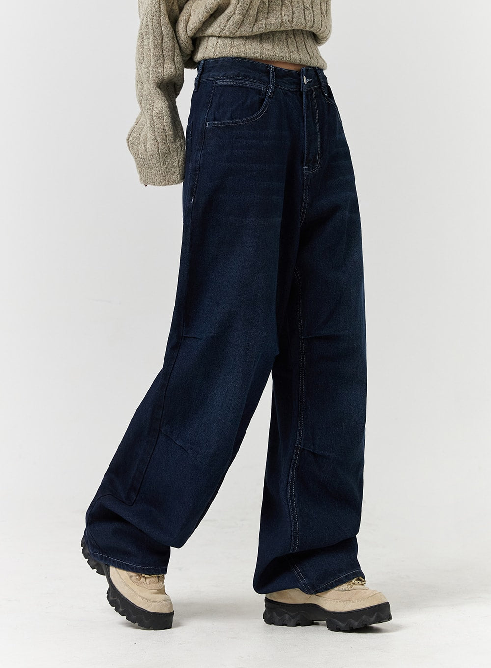 Unisex High Waist Solid Pocket Straight Leg Jeans CD328 in Blue, side close-up on model from waist down, highlighting wide-leg silhouette, panel seam detail, and dark indigo washed denim texture.