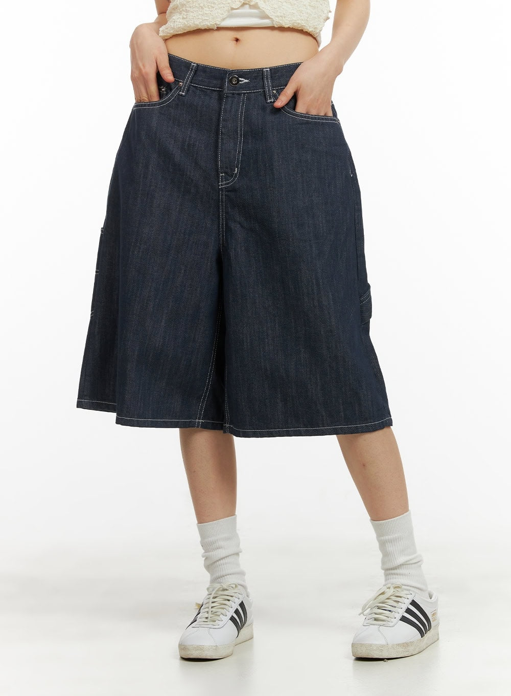 Solid Wide-Leg Bermuda Jorts CY414 in dark blue, front mid-shot on model hands in pockets, wide-leg cotton denim with contrast white stitching and side utility pocket detail.