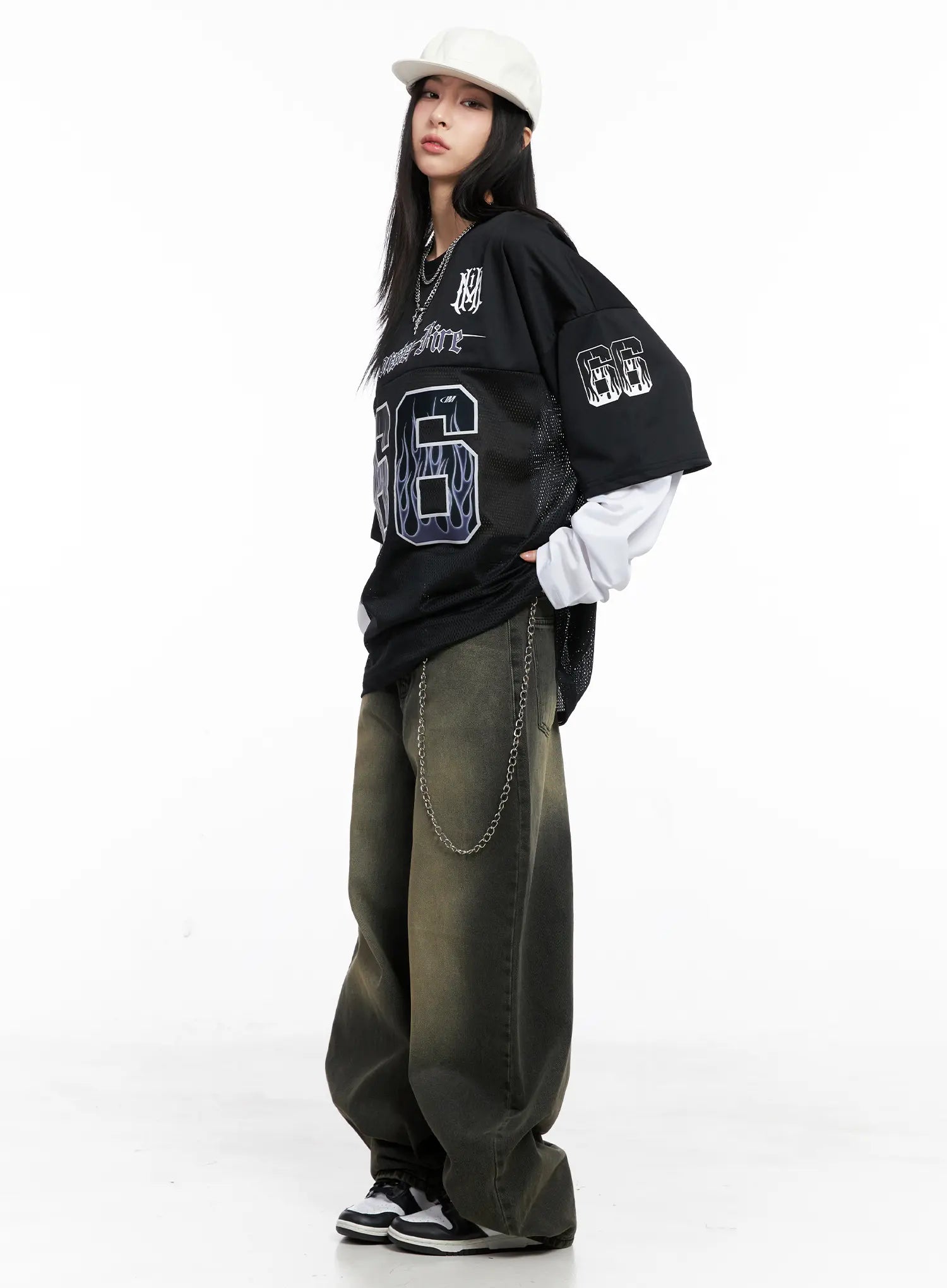 Elias Mega Wide Vintage Washed Jeans CC1109 in black, three-quarter front editorial shot on model, paired with graphic jersey, layered white tee, chain belt, and cap.