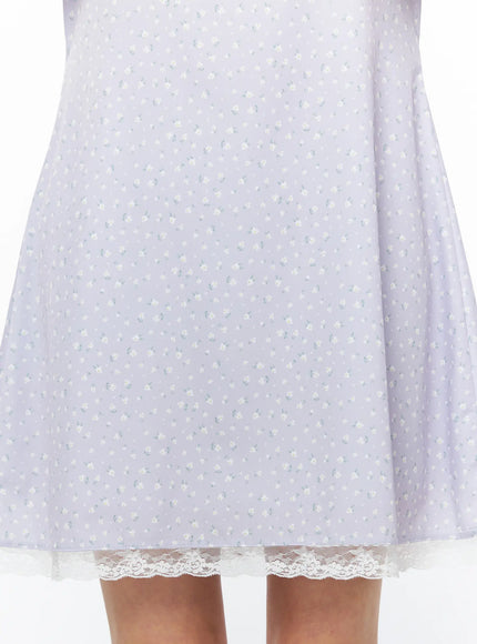 Romantic Floral Lace Trim Mini Dress CU522 in light purple, close-up detail of skirt hem, small white floral print on soft fabric, cream scalloped lace trim clearly visible at hem edge.
