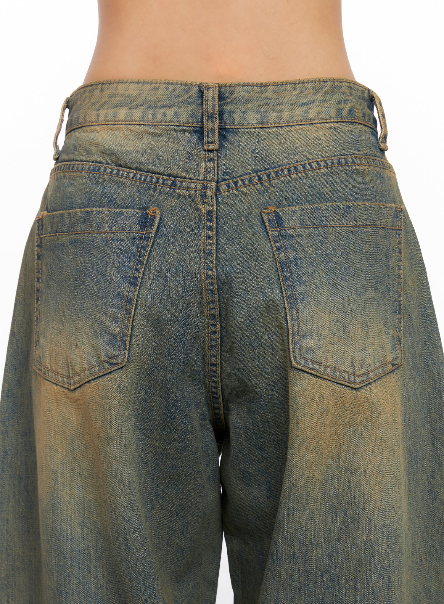 Miley Washed Balloon Baggy Jeans CO515 in vintage green-blue wash, back waist close-up on model, showing dual patch pockets, belt loops, and uneven amber washed denim detailing.