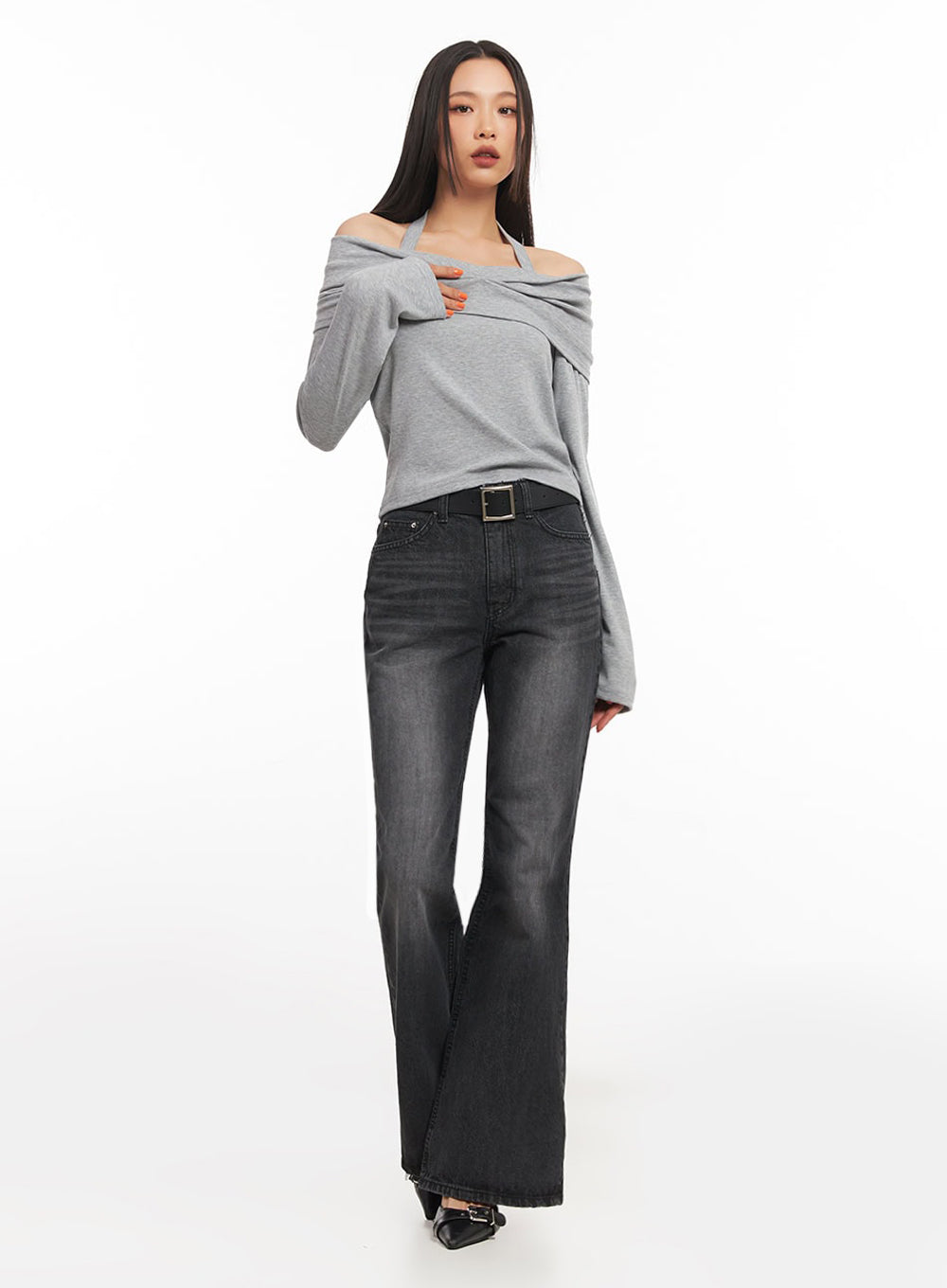 Joanna Washed Flared Jeans IA504 in washed black, three-quarter front on model, slim high-rise fit with black square-buckle belt, long flared leg, styled with grey off-shoulder knit top.