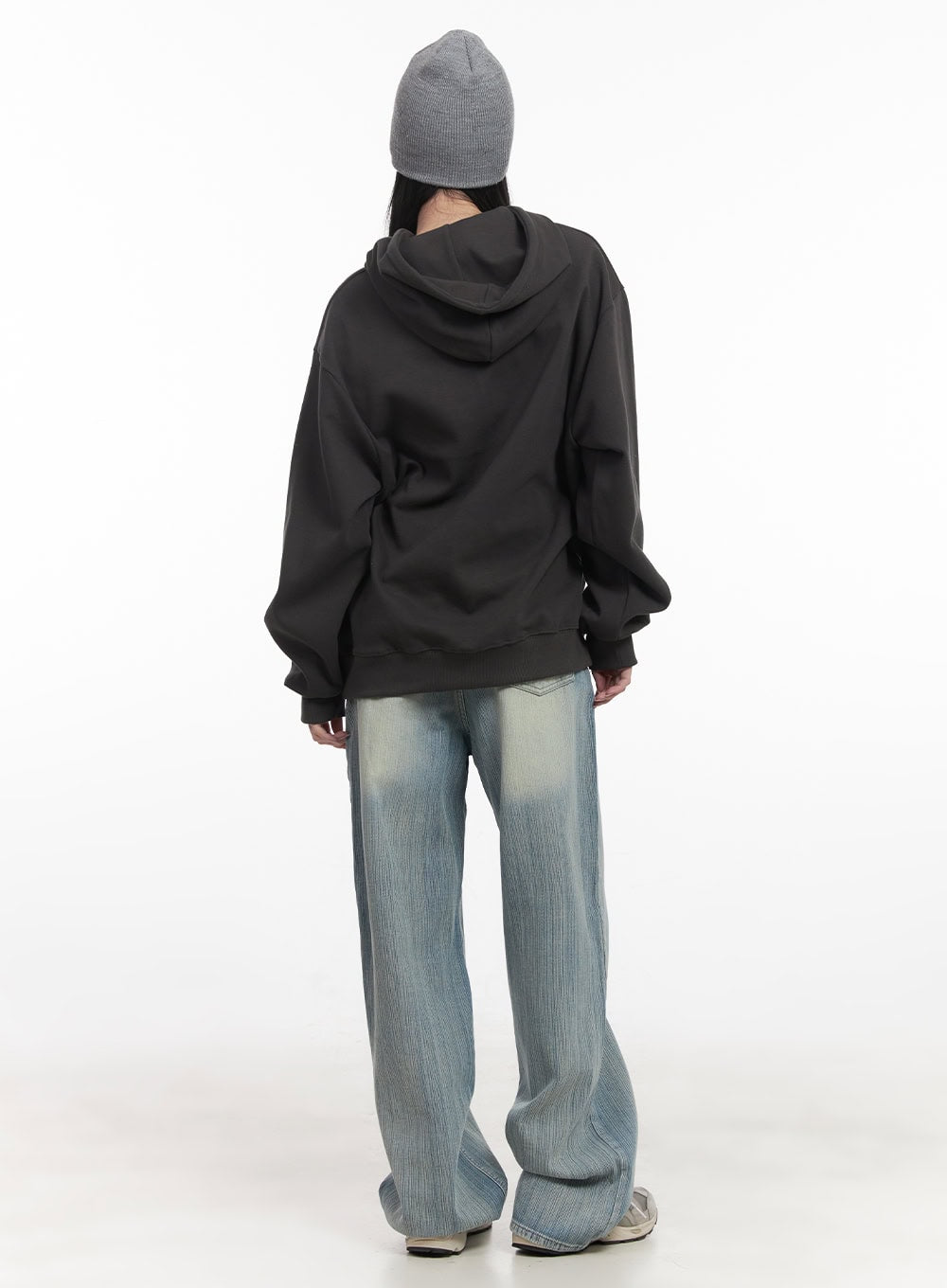 Nicola Washed Wide-Leg Jeans CF514 in light blue, full-body back view on model, wide-leg denim pooling at floor, paired with dark oversized hoodie and grey beanie.