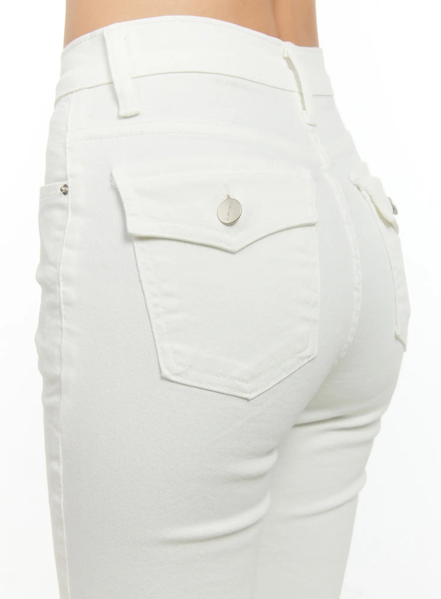 High-Waist Flare Pants CG501 in white, back close-up detail on model, showing flap back pockets with silver rivet hardware and smooth cotton fabric.