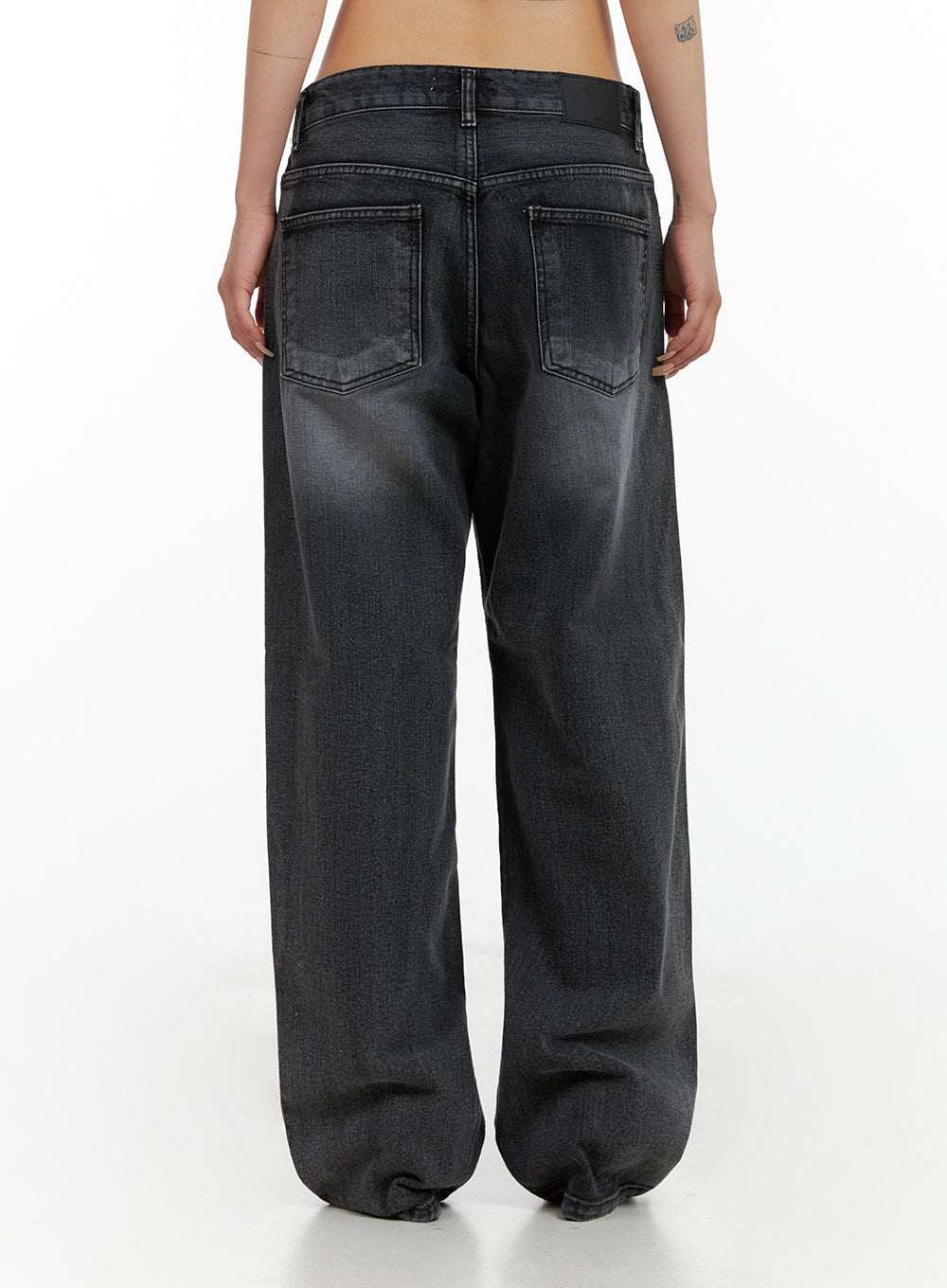 Low Rise Wide Leg Jeans CL415 in black, back close-up crop view on model, back pockets with contrast stitching, washed denim texture, wide leg silhouette.