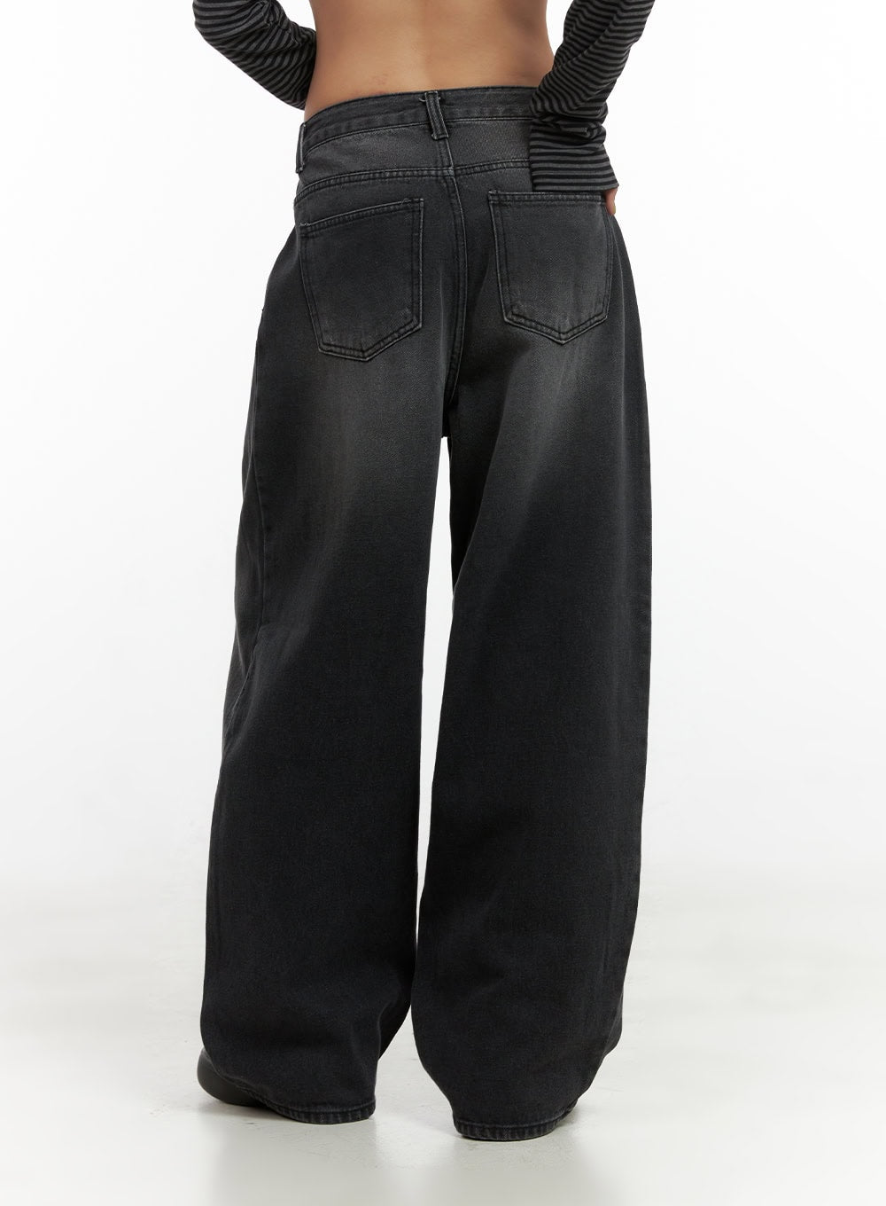 Delilah Pin-Tuck Washed Denim Baggy Jeans CO424 in black, rear waist-to-hem close-up on model, dual back pockets with topstitching and voluminous wide leg in washed cotton denim.