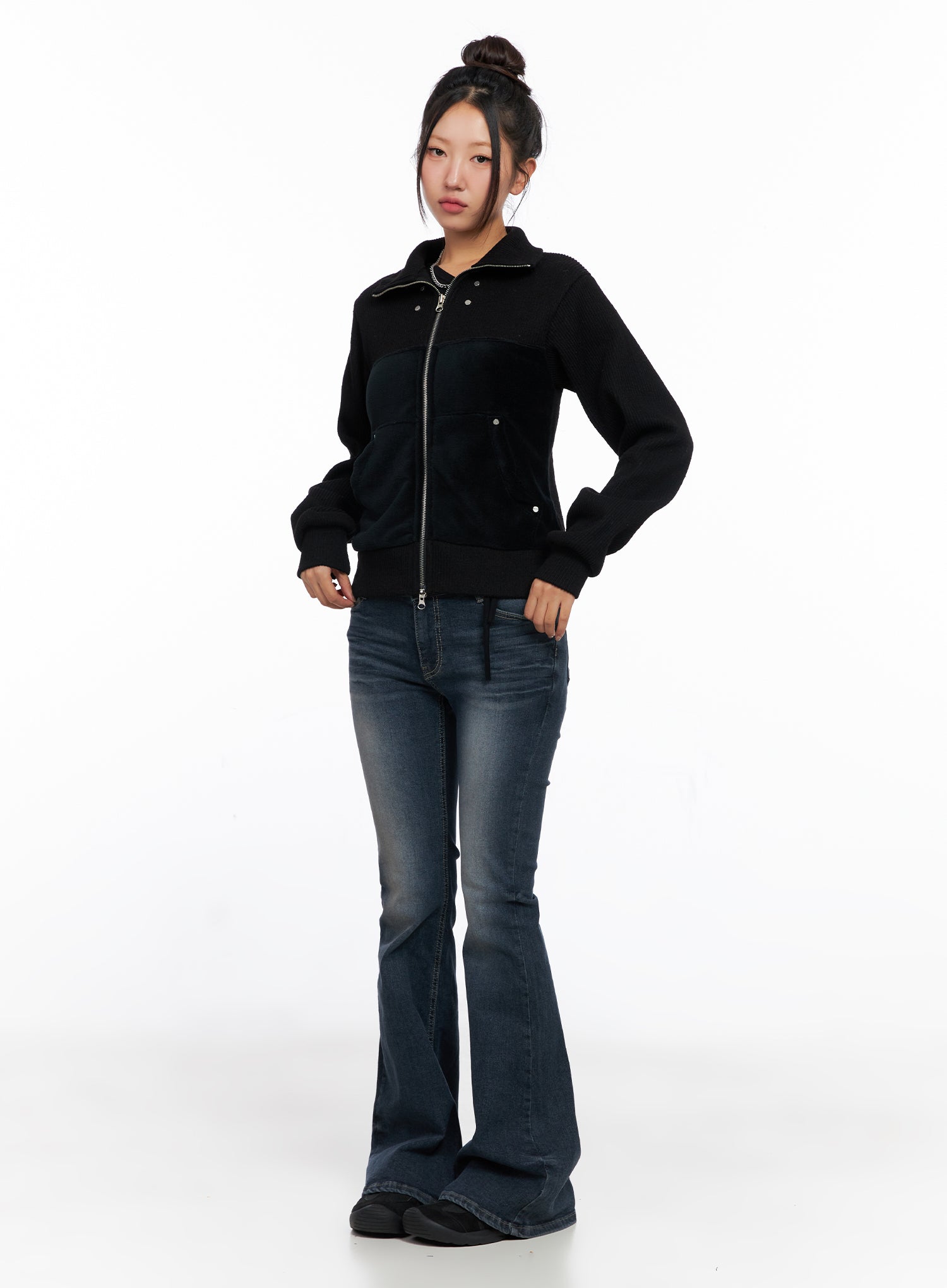 Melina Hip-Pad Low-Rise Flare Jeans CO514 in dark blue, full-body front on model styled with black zip-up velour jacket and chain necklace, standing straight, flare hem pooling at feet.