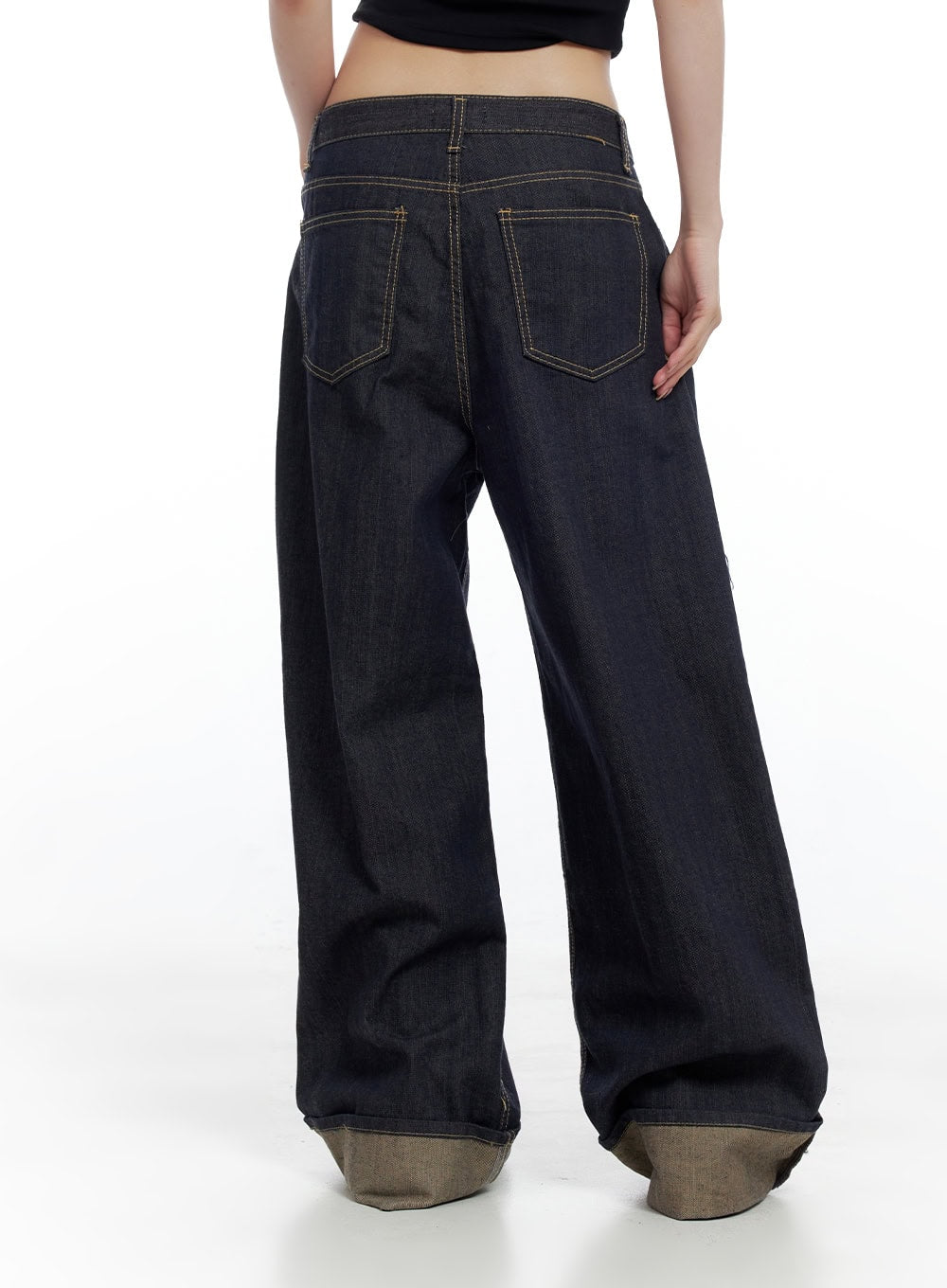 Sadie Roll-Up Denim Jeans CO426 in dark blue, back three-quarter shot on model, wide-fit baggy leg with contrast khaki cuff roll-up, gold topstitching on back pockets and waistband.