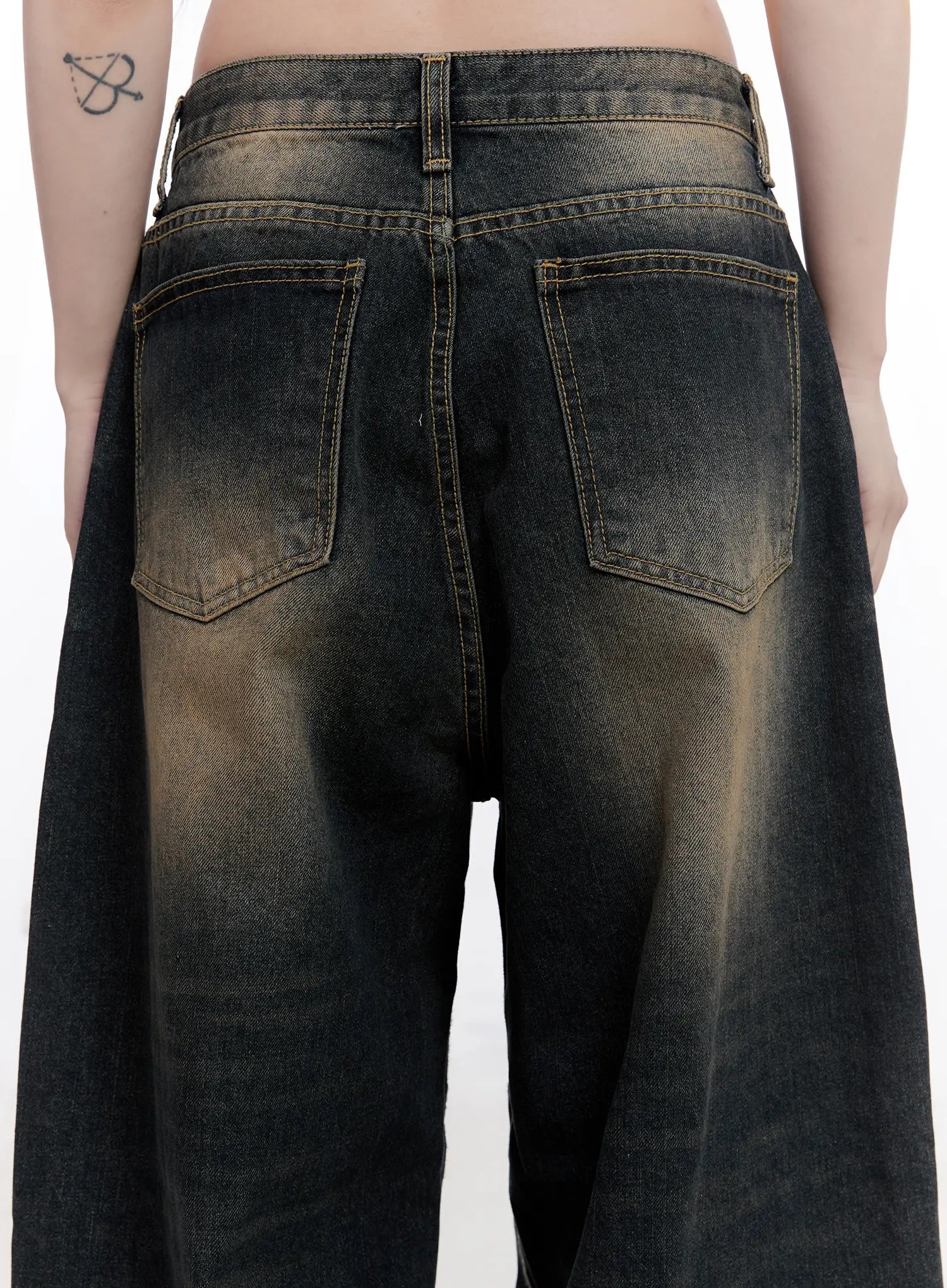 Sylvia Vintage Washed Baggy Jeans CO501 in dark blue, back close-up on model, showing dual back pockets with contrast stitching, amber vintage wash across seat and thigh, cotton denim.