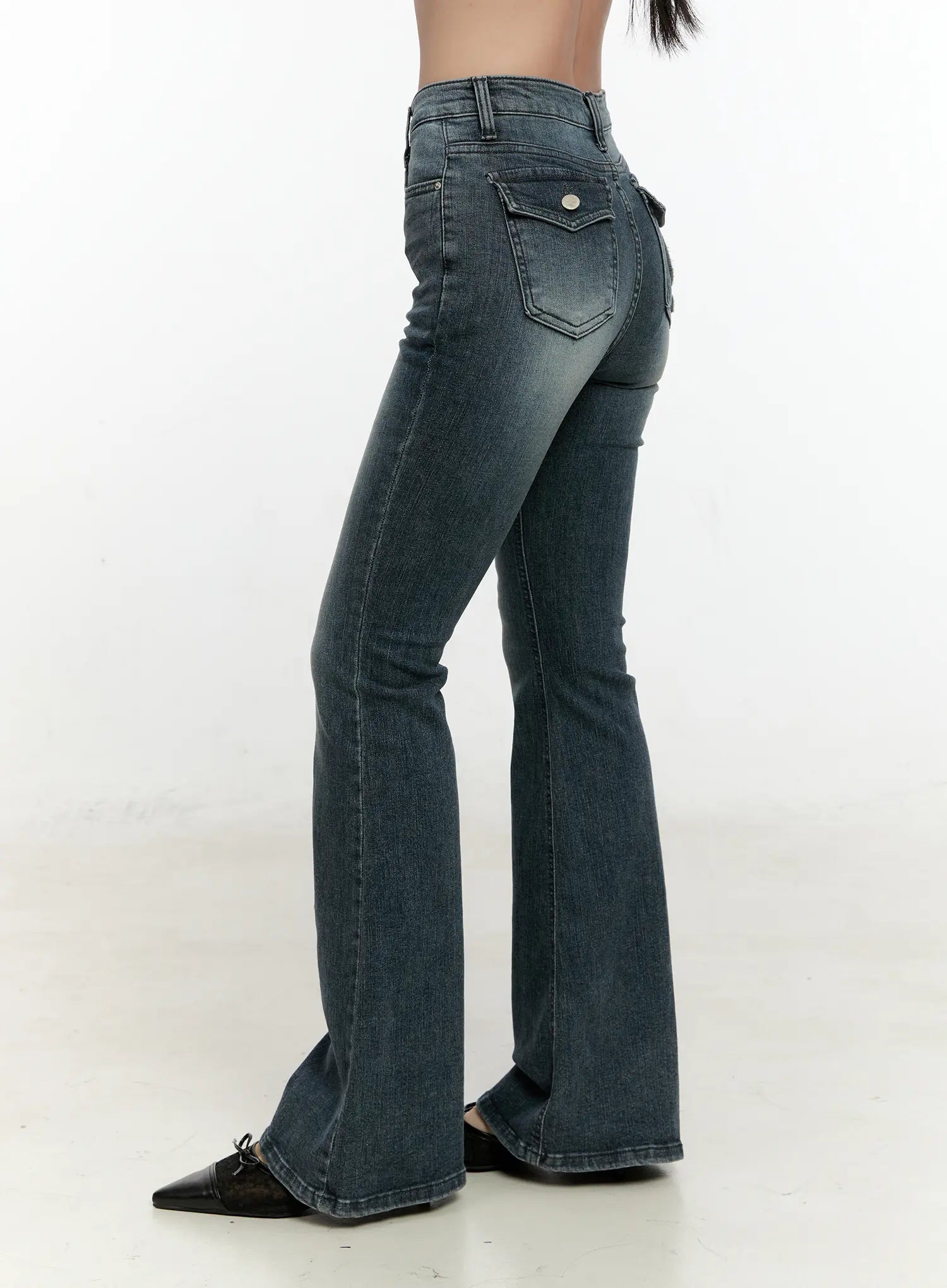 Marley Hip-Pad Denim Bootcut Jeans CN506 in dark blue, rear three-quarter headless view on model, hip-pad shaping and snap-button back pocket detail, washed stretch denim bootcut silhouette.