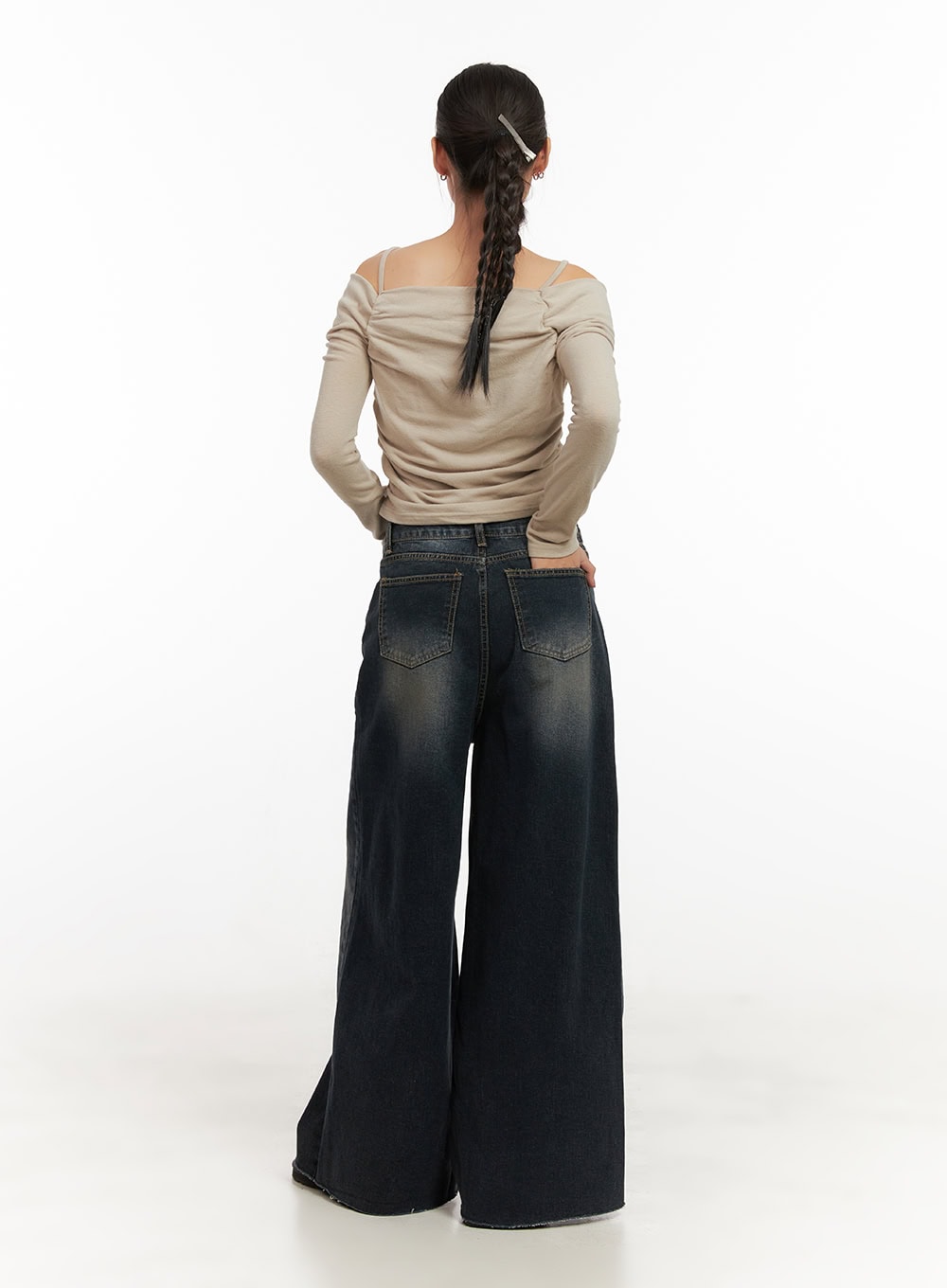 Tasha Low Waist Washed Wide Leg Jeans CD410 in dark blue, full back view on model, low-rise washed denim, oversized wide-leg silhouette, raw hem at floor length, styled with off-shoulder beige ruched top.
