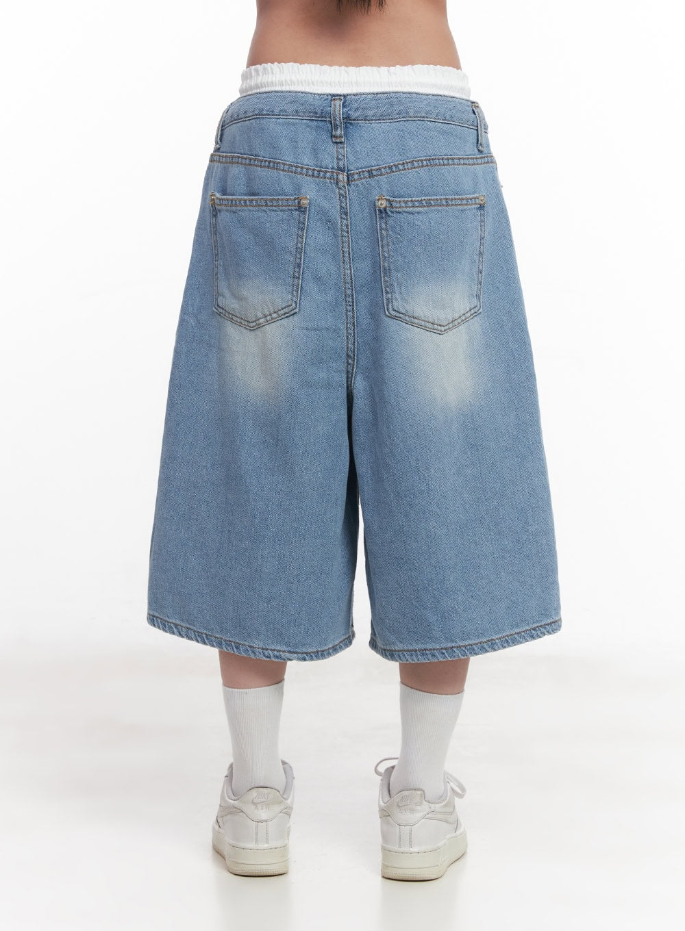 Layered Drawstring Baggy Jorts CY527 in light blue, back view on model, dual patch pockets with visible fading on washed denim, white ruched inner waistband detail, paired with white socks and sneakers.