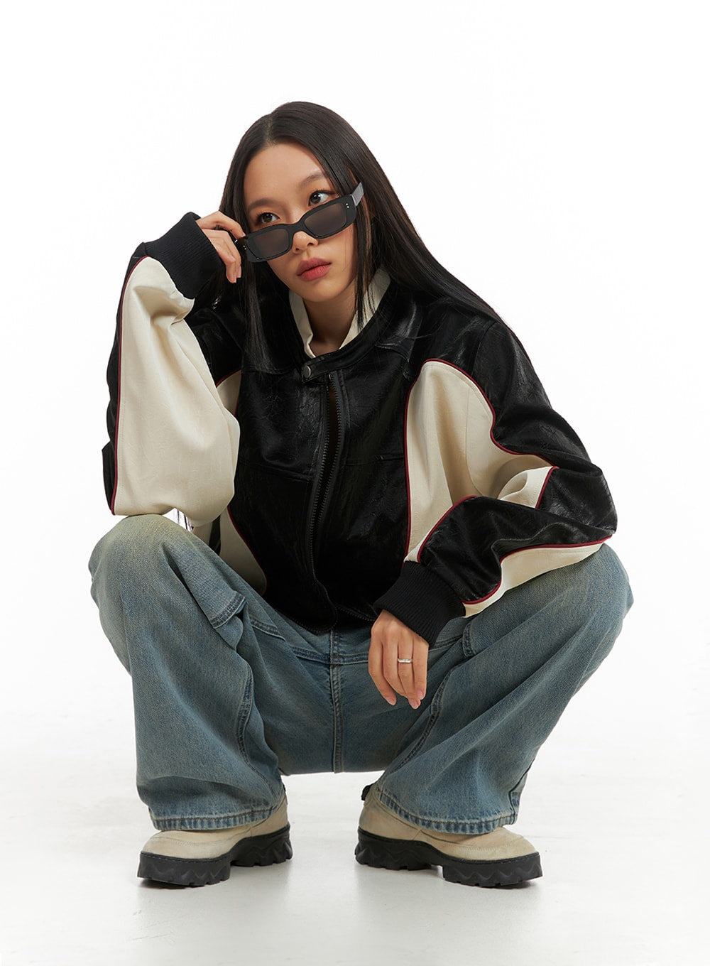 Washed Denim Wide Leg Jeans IA417 in blue, crouching model dynamic pose, wide leg washed denim with faded yellow wash, styled with bomber jacket and chunky boots.