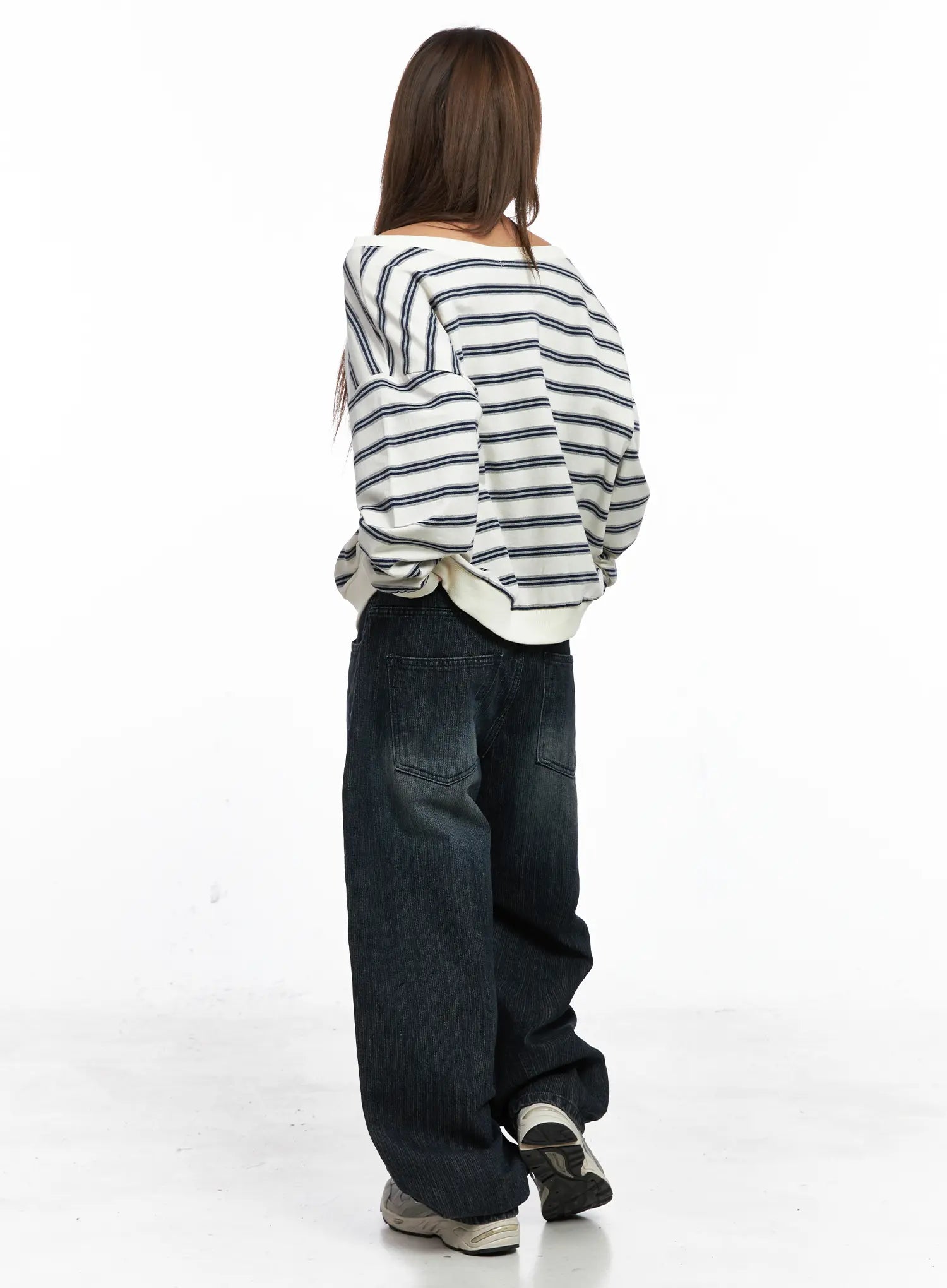 Aspyn Wide-Leg Washed Corduroy Jeans CO510 in dark blue, back full-body on model, wide-leg corduroy hem pooling over sneakers, styled with striped top, back pocket detail visible.