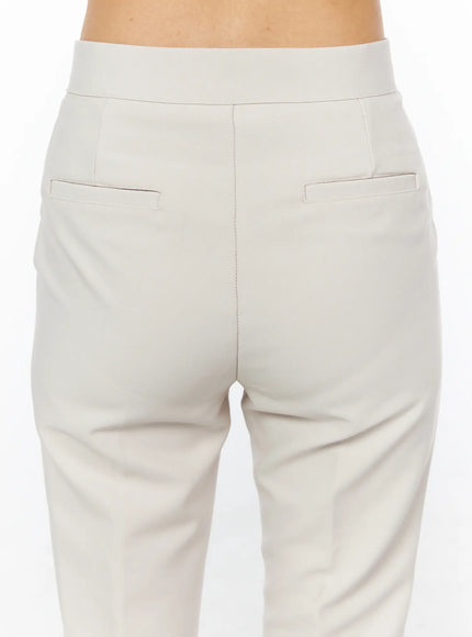 High-Waist Stretch Flared Slacks CU522 in light beige, back waist close-up on model, showing wide high waistband, two welt back pockets, and center back seam.