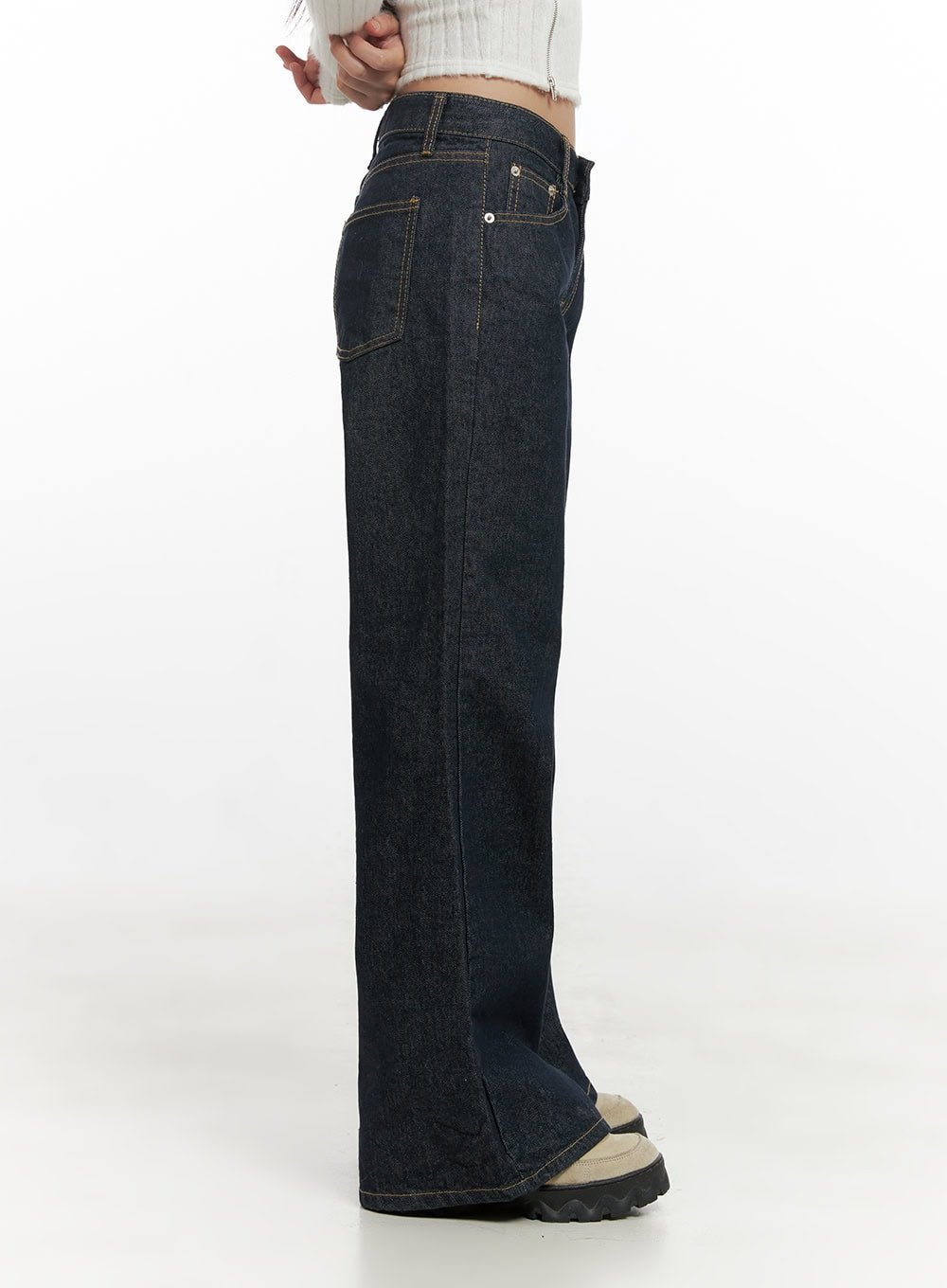 Lisa Cotton Comfort Wide Leg Jeans CN419 in dark blue, side mid-shot on model, low-rise cotton denim with visible front pocket stitch detail and wide leg opening, paired with white ribbed crop top.