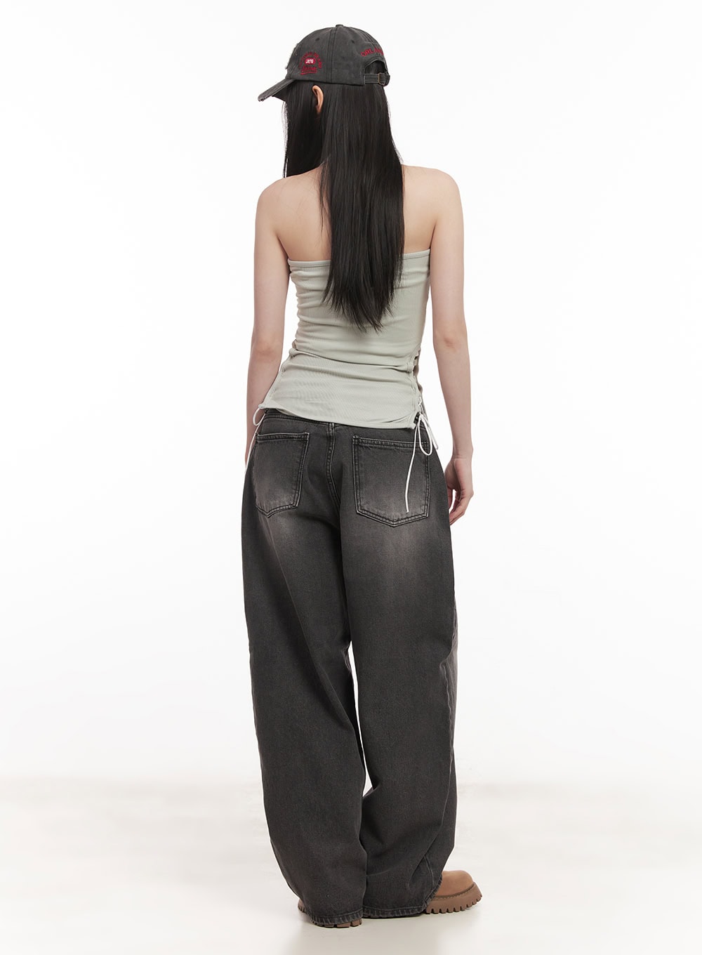 Dianna Baggy Jeans CM518 in dark gray, full-length back on model, back pockets and washed fade visible, paired with ribbed tank and logo baseball cap.