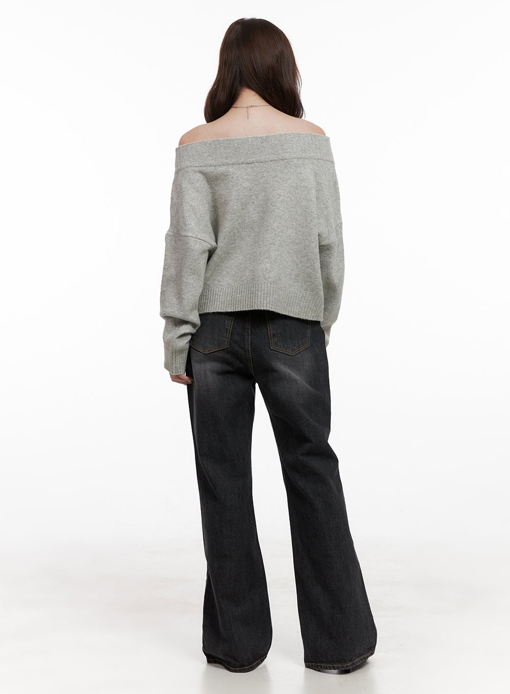 Kiana Cotton Wide Fit Flared Jeans OD403 in black, full back view on model, high-rise washed flared jeans with back pockets, paired with grey off-shoulder knit sweater and black heels.
