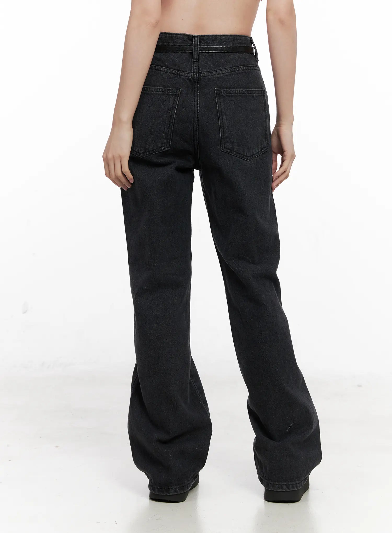 Eileen Belted Flare Jeans CN504 in washed black, back view from waist to hem on model, showing dual back pockets, belt loop detail, and flared leg silhouette in washed cotton.
