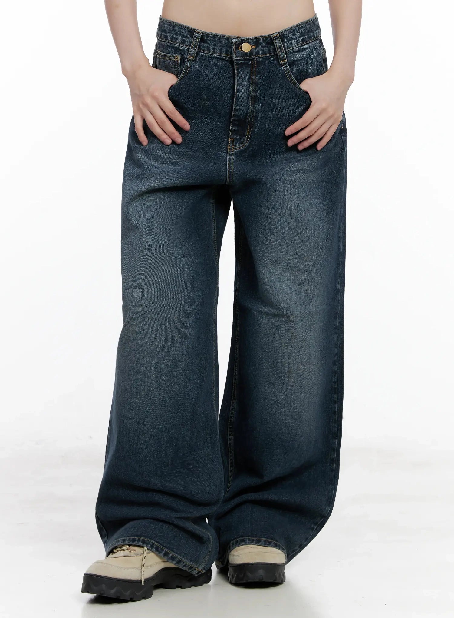 Mashiro Vintage-Wash Wide Jeans IL531 in dark blue, front lower-body shot on model, hands resting on pockets, showing full wide-leg sweep and faded wash on cotton denim, with chunky sneakers at hem.