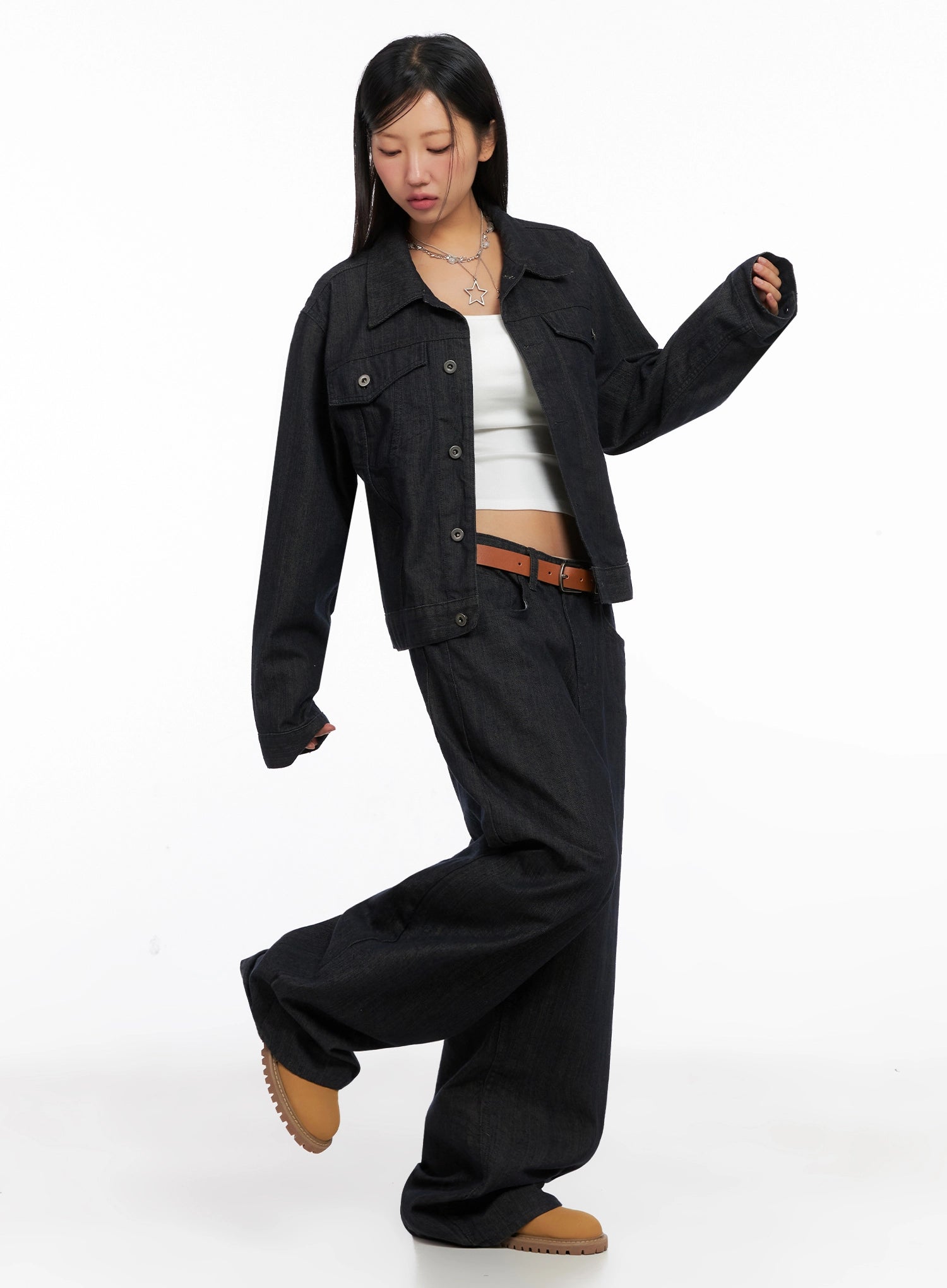 Heidi Wide-Leg Jeans IG527 in dark blue, dynamic full-body shot on model mid-stride, wide cotton denim leg sweeping out, styled with dark denim jacket and white crop top.