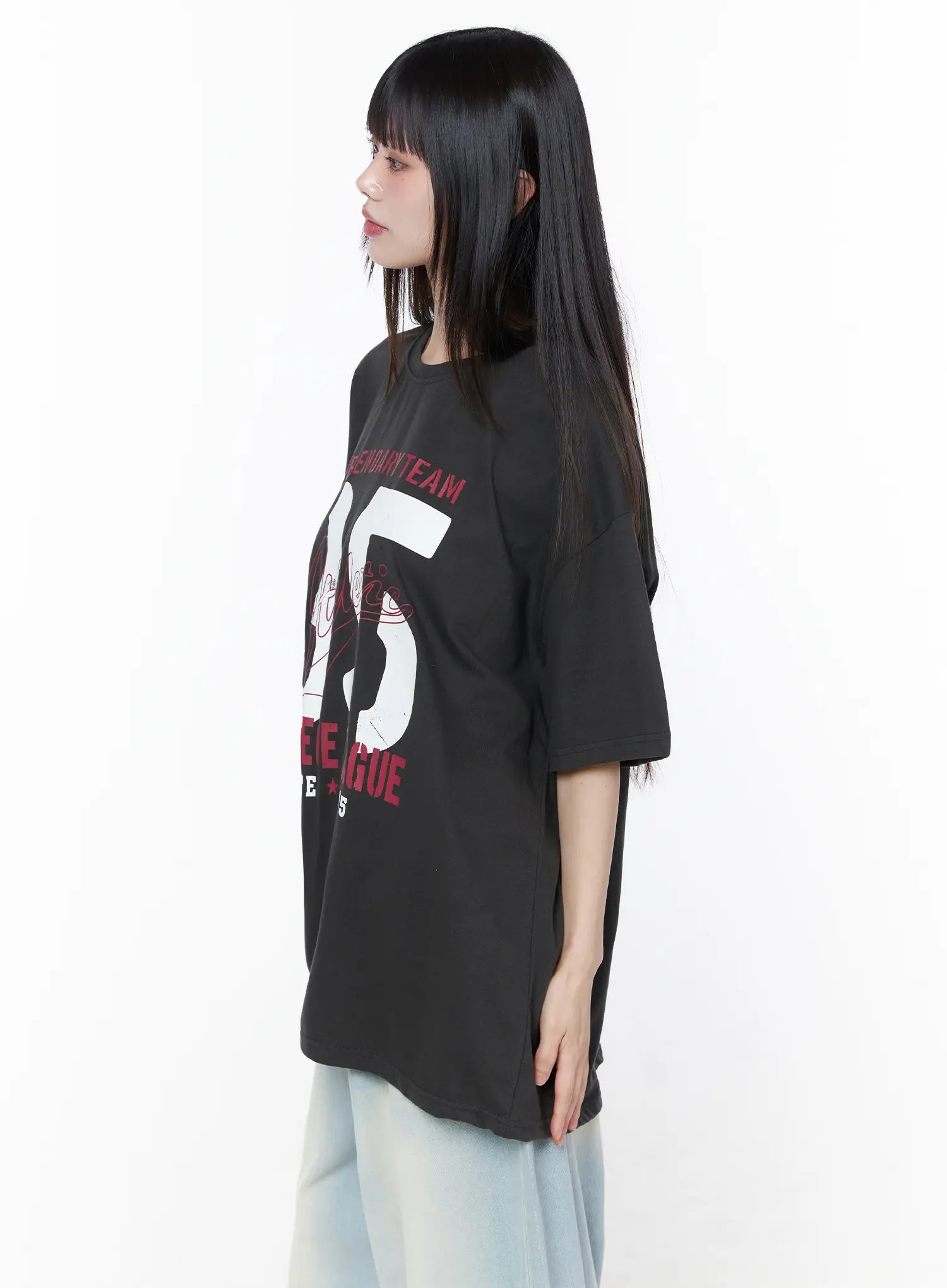 Oversized Graphic Tee CU519 in dark gray, side close-up on model, highlighting the oversized boxy silhouette, dropped shoulder seam, and 95 graphic wrapping around the torso, with light jeans.