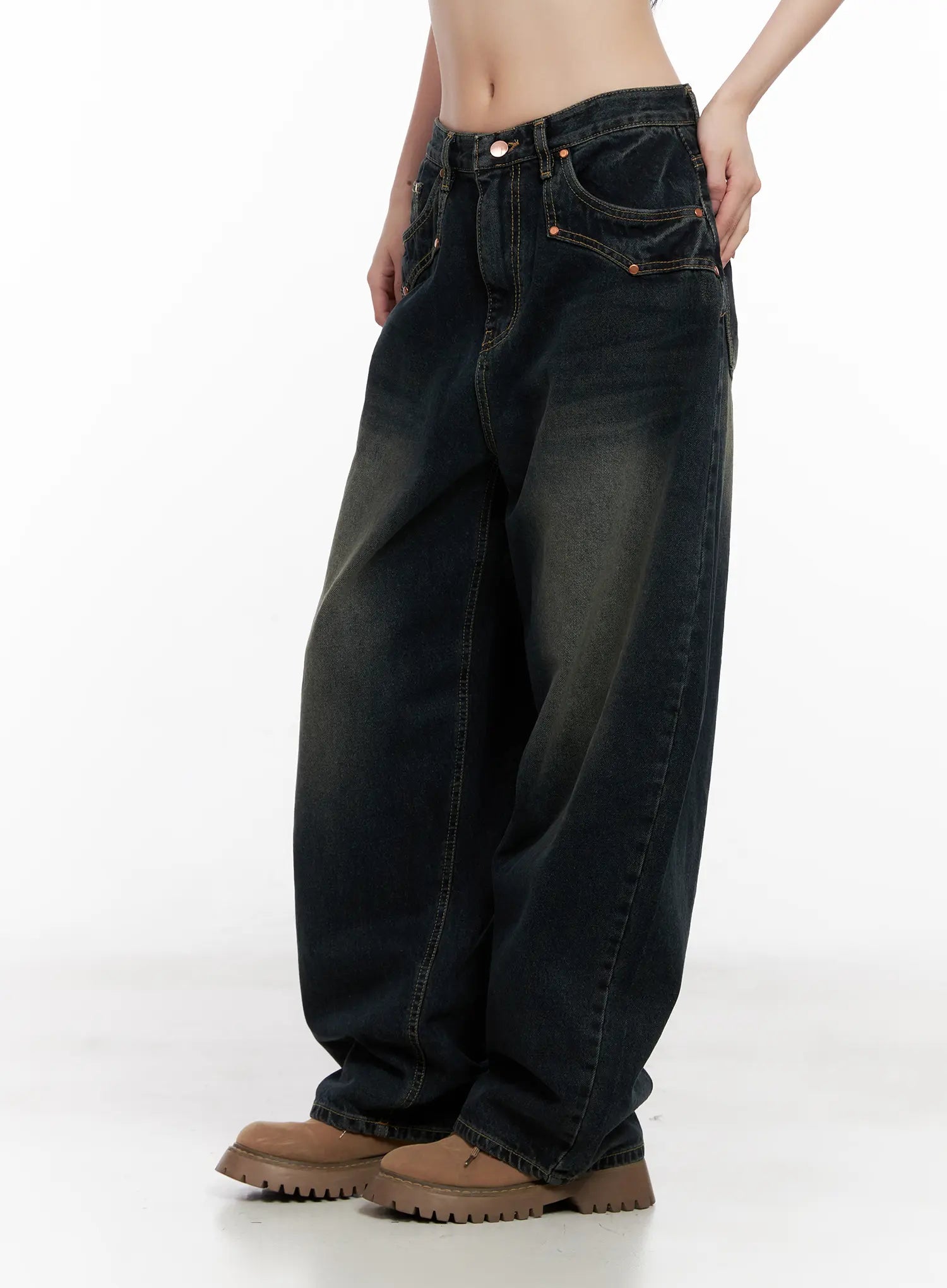 Hyer Washed Wide-Leg Jeans CG522 in dark blue, side-angled crop view on model, low-rise waistband with orange rivets and contrast stitching, washed denim with yellow fade detail at thighs.
