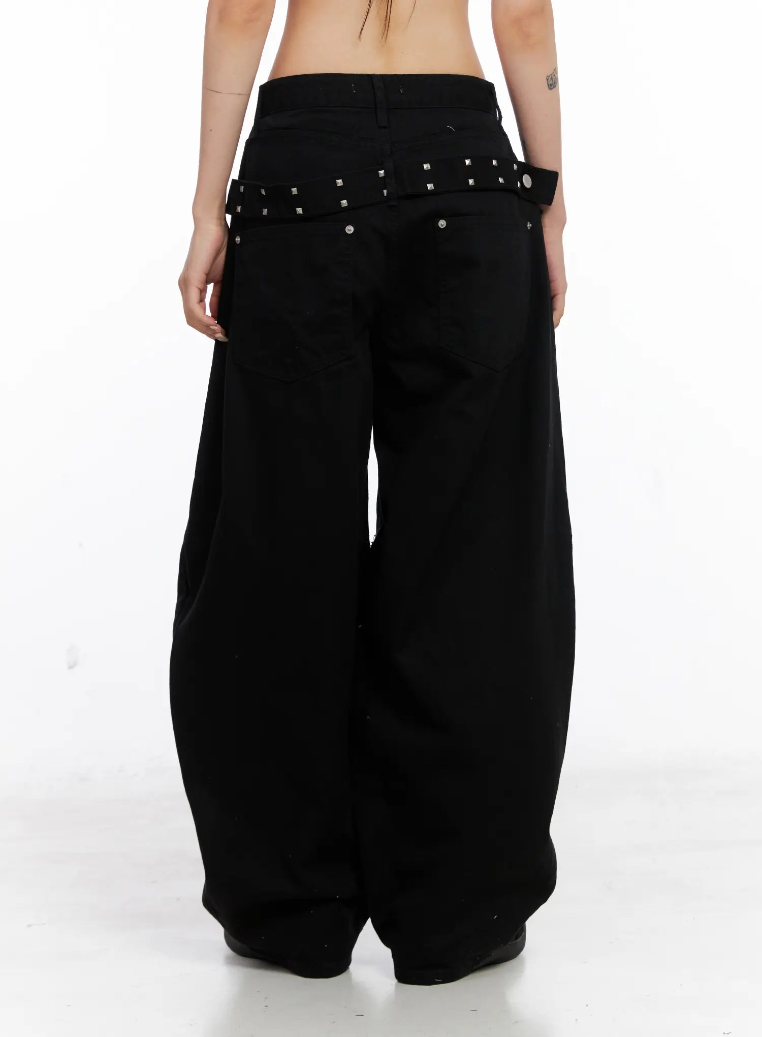 Nana Studded Belt Balloon Jeans CS512 in black, back full-length on model, wide balloon leg silhouette, silver square-stud belt across waistband, cotton fabric with soft drape.