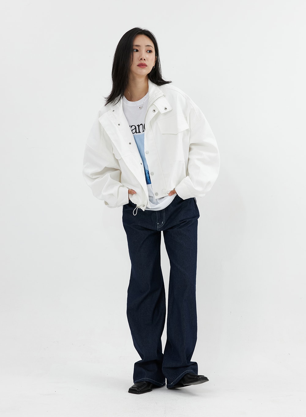 Stitched Jeans OO305 in Blue, front full-length on model, wide-leg indigo denim with contrast stitch, layered under white oversized jacket and graphic tee.