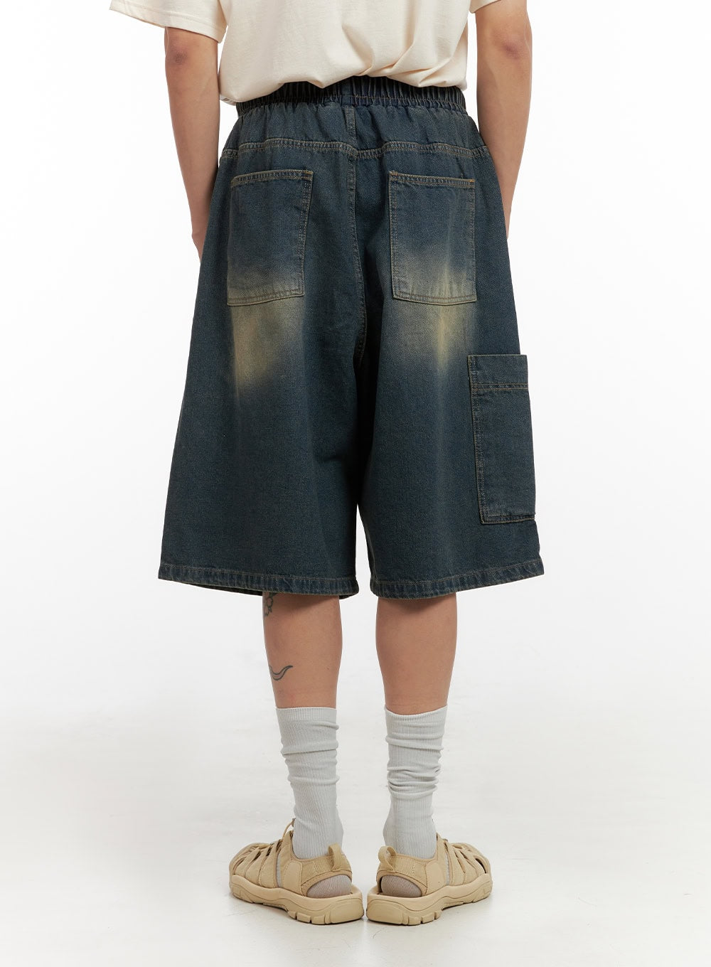 Men's Denim Washed Shorts (Blue) IL404 in blue, back view on model, showing two back patch pockets, side cargo pocket, elastic waistband, and vintage sun-faded wash detail.