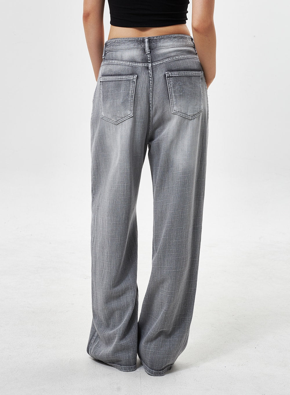 Mid-Rise Wide Leg Jeans CY330 in grey, back close-up on model, dual back patch pockets with stitching, faded wide-leg cotton denim, full length.
