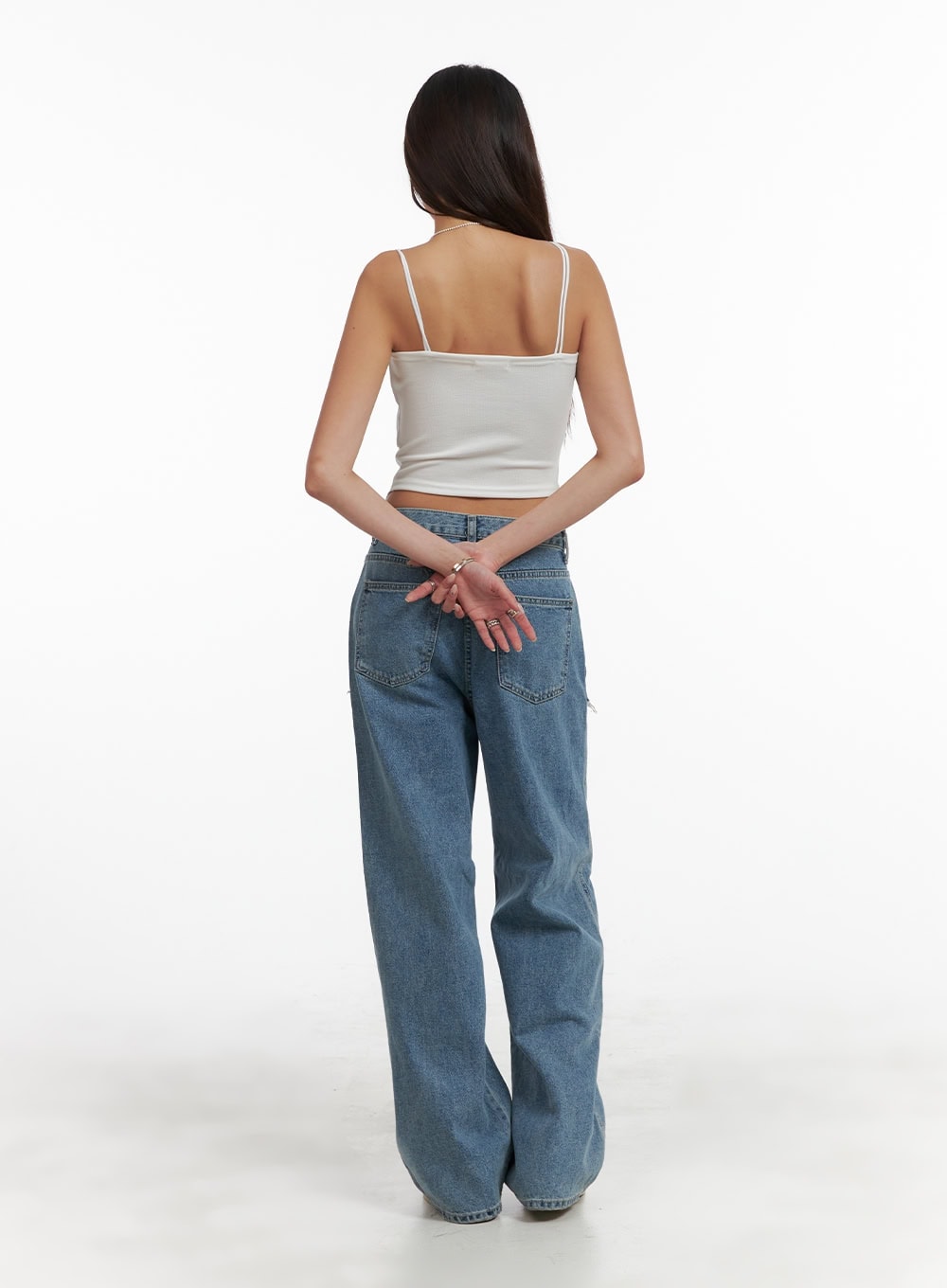 Layered Wide Leg Jeans CA430 in Blue, full-length back view on model, wide-fit washed denim, back pockets and slightly visible side destroyed fringe detail, paired with white spaghetti-strap crop top.