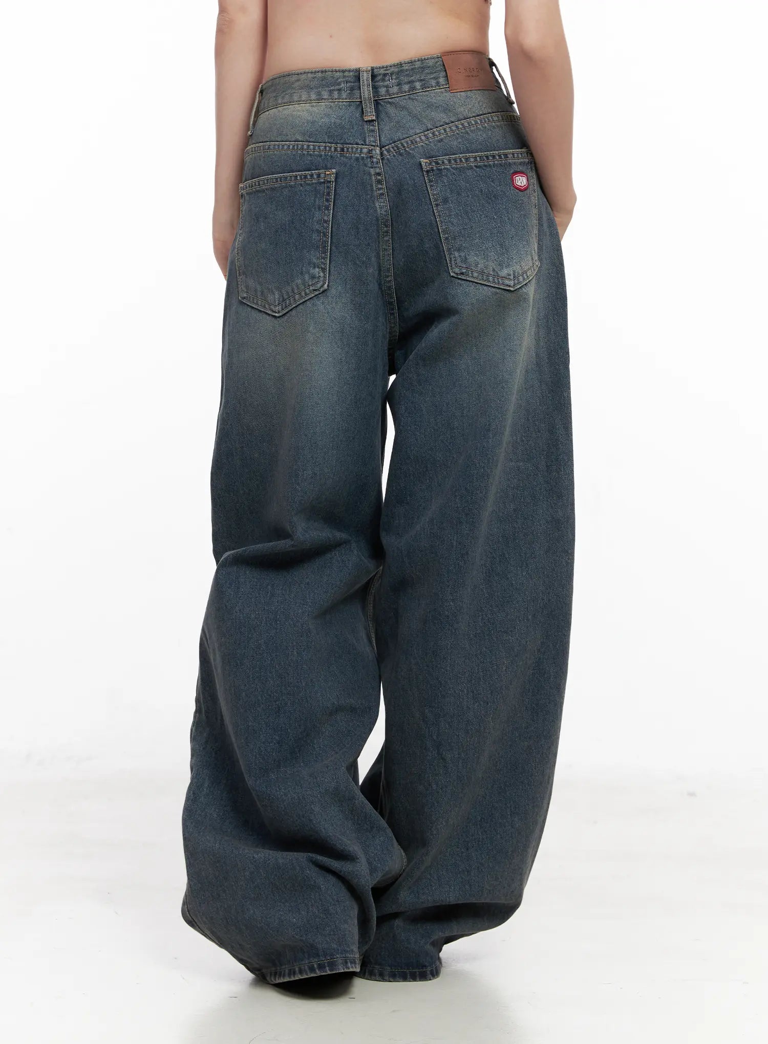 Tutt Washed Wide Leg Jeans CN504 in vintage blue, full back view on model without top, double back pockets with red badge patch, wide pooling hem and washed fading detail.
