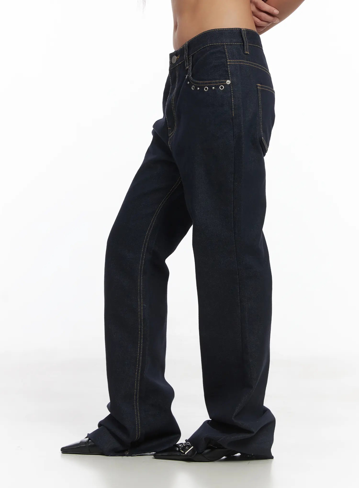 Bunn Non-Fade Eyelet Bootcut Jeans CJ512 in dark blue, side-angle product shot on model, contrast topstitching, eyelet hardware on front pocket, long wide bootcut leg, no top worn.