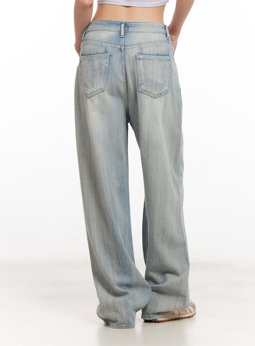 Jessi Washed Wide-Leg Jeans CA514 in light blue, back product shot on model, showing dual patch pockets with topstitching, belt loop waistband, and faded wide-leg denim hem.