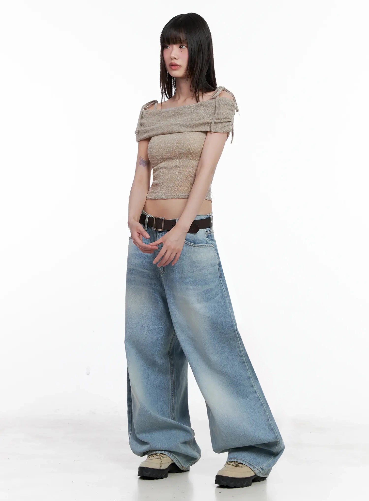 Dain Washed Wide-Leg Jeans IL531 in light blue, three-quarter side view on model with slight turn, wide-leg silhouette with washed gradient visible, styled with crop top and belt.
