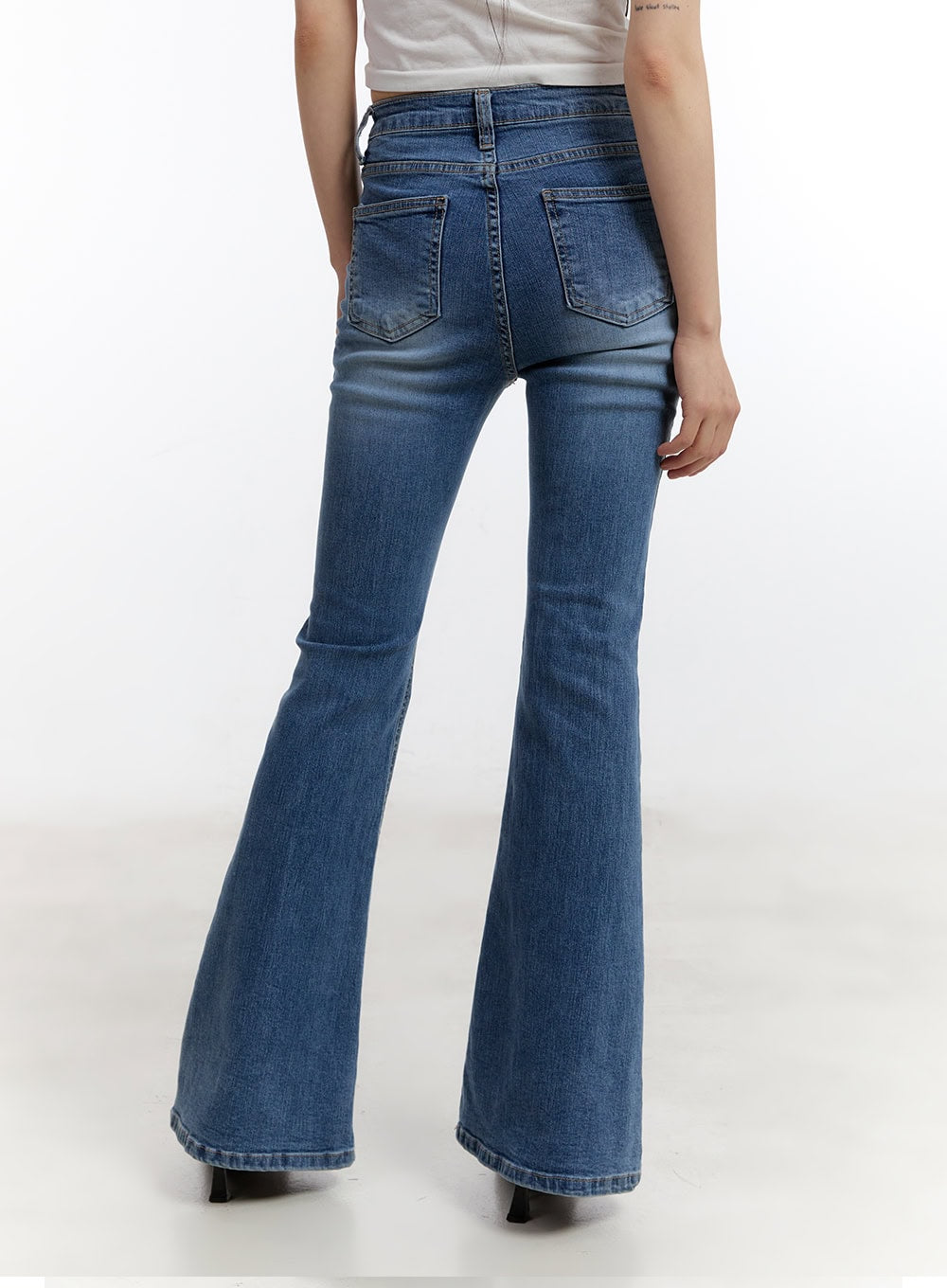 Maris Hip-Pad Bootcut Jeans CA508 in blue, back crop view on model, washed denim highlighting hip-pad silhouette, dual back pockets, and bootcut flare, with white crop top.